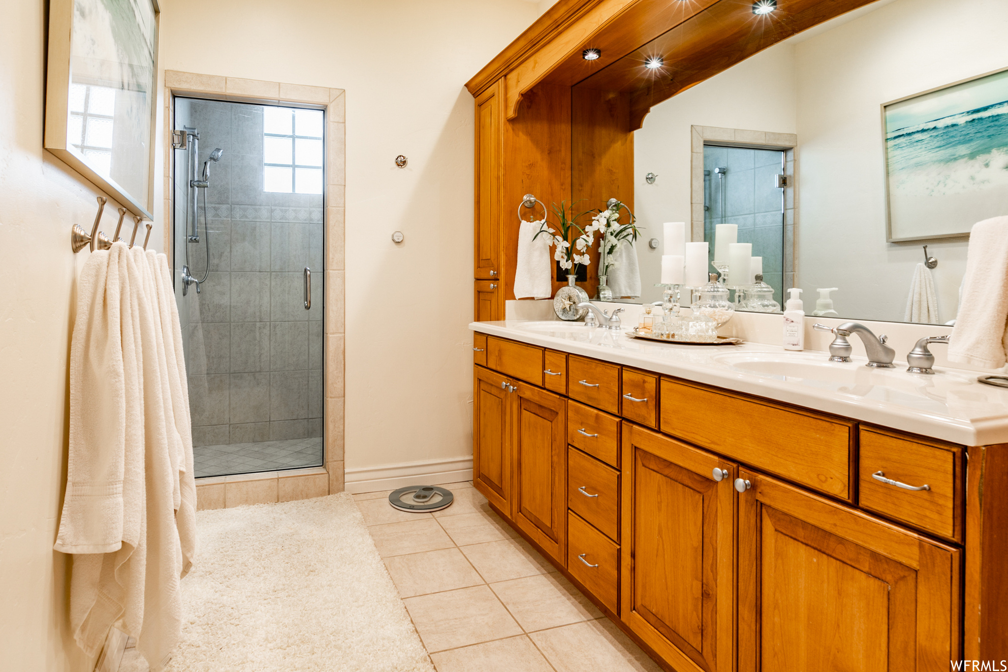 Extra-long vanity with lighted, canopied counter top & double sinks. Huge Shower has a glass block window. There is a partitioned room for the toilet.