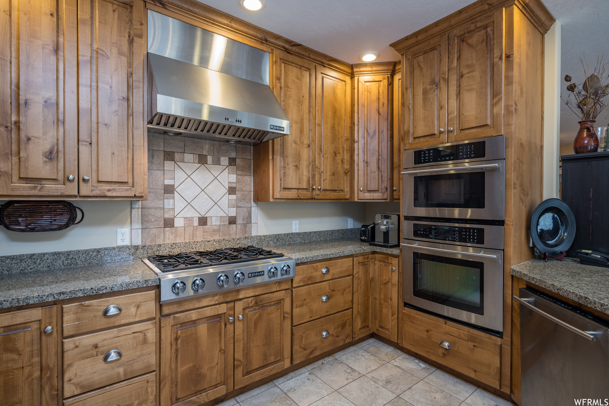 Six Burner Gas Cooktop, Hood Vent, Gas Convection Wall Oven, with Built-in Microwave above.