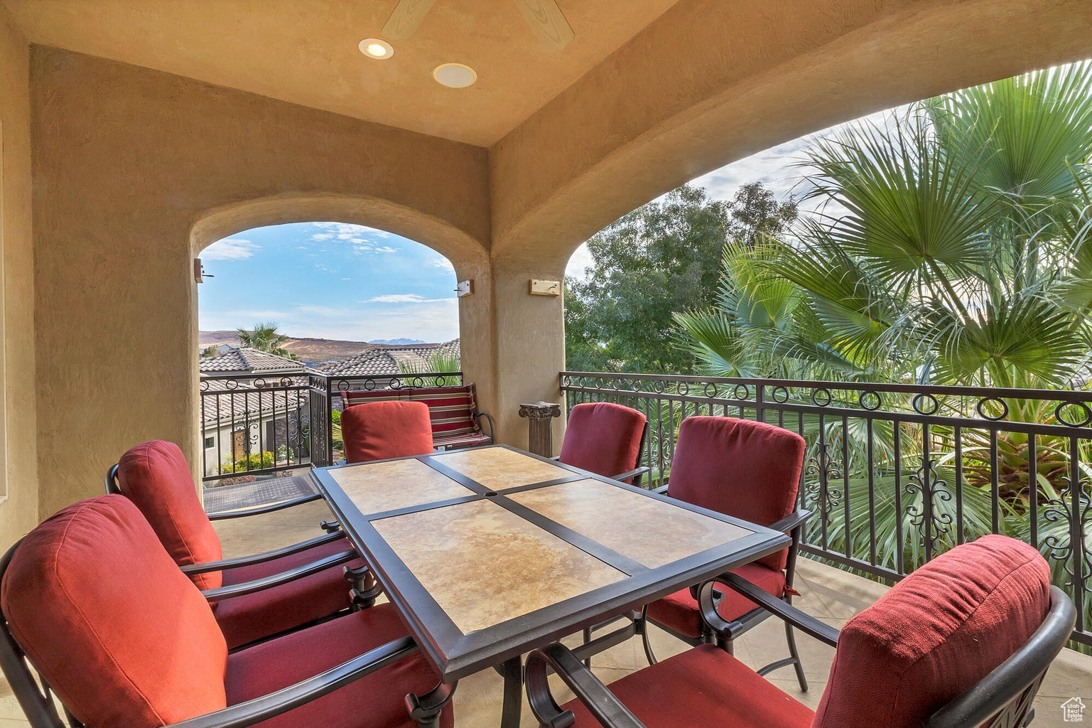 View of patio with a balcony