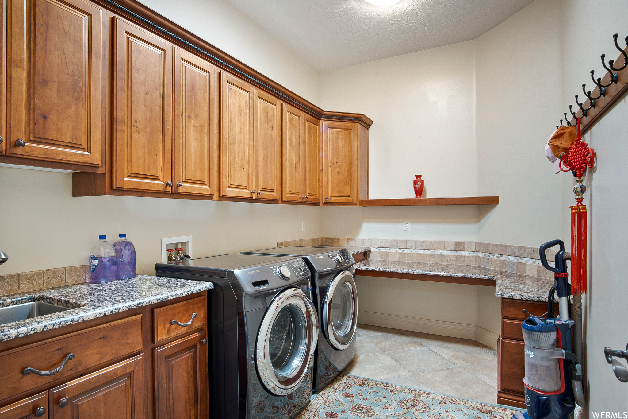 Laundry area featuring tile floors