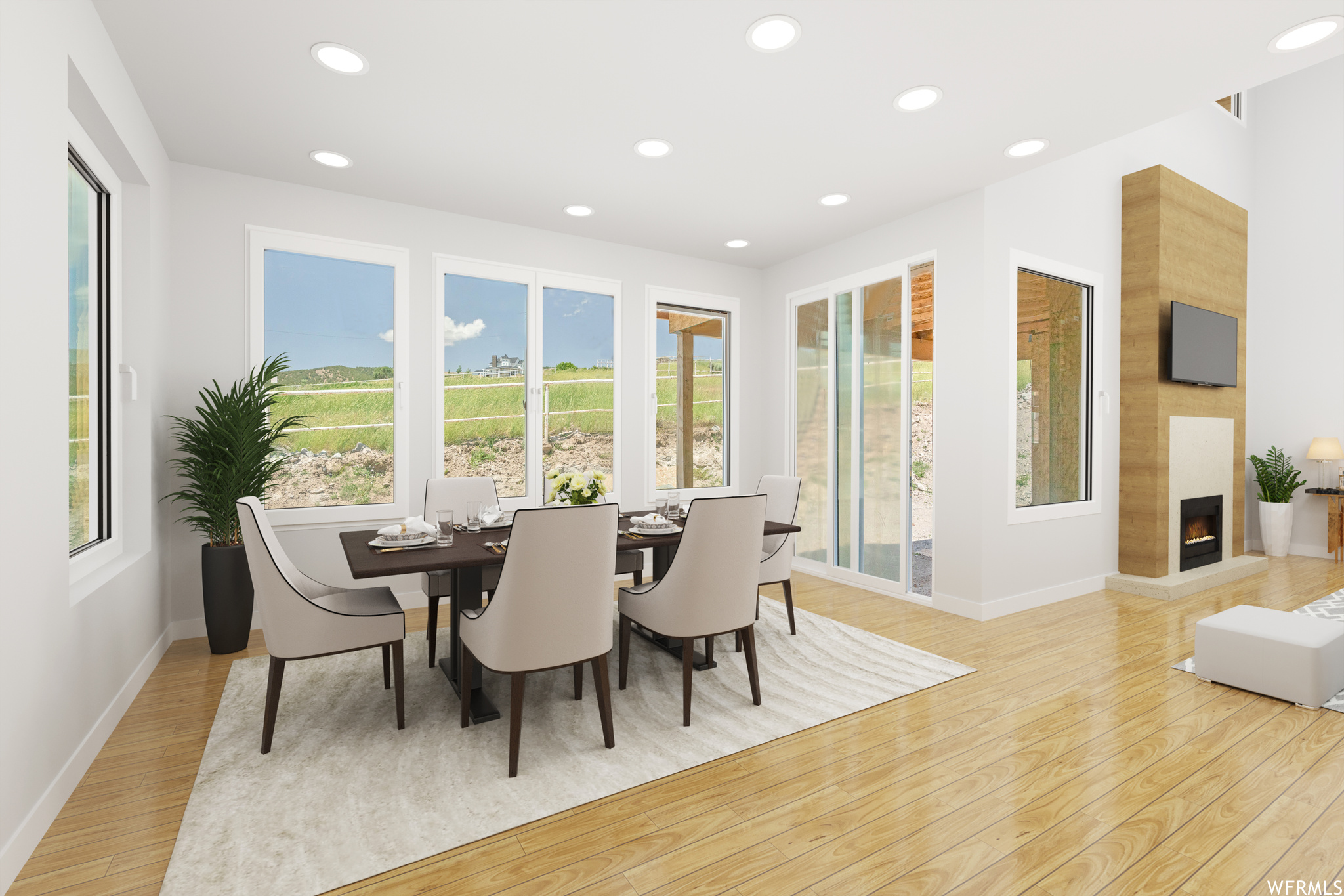 *Virtually Staged* Dining room featuring hardwood flooring, a fireplace, and natural light