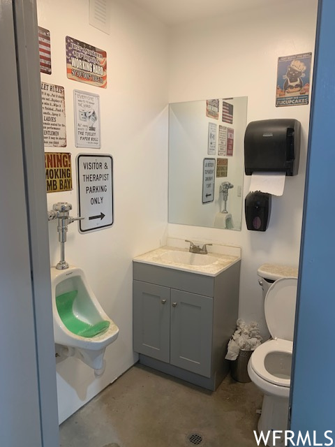 Half bath with toilet, mirror, and vanity
