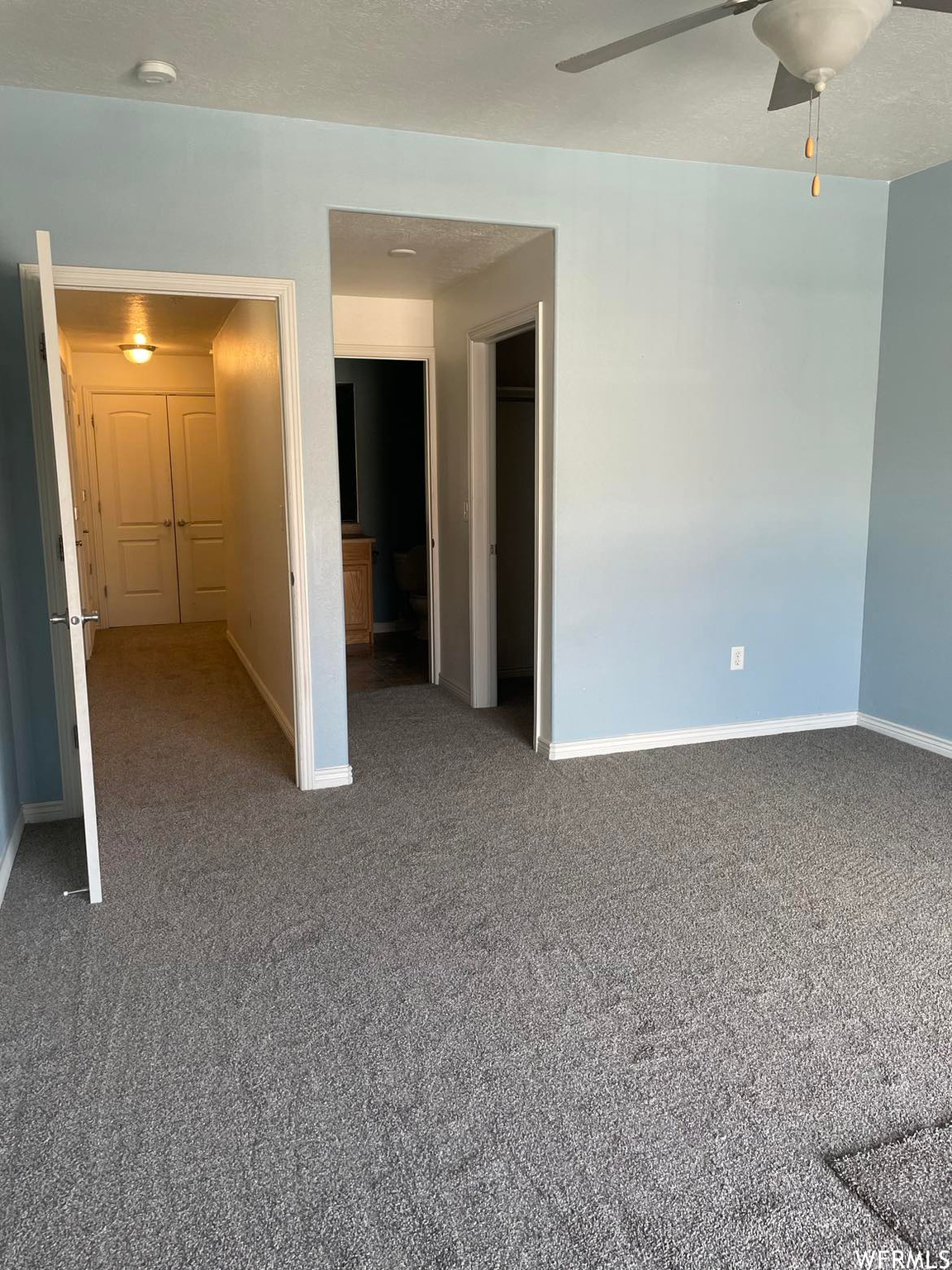 Spare room featuring a ceiling fan and carpet