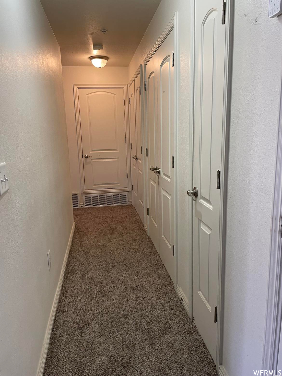 Corridor featuring carpet