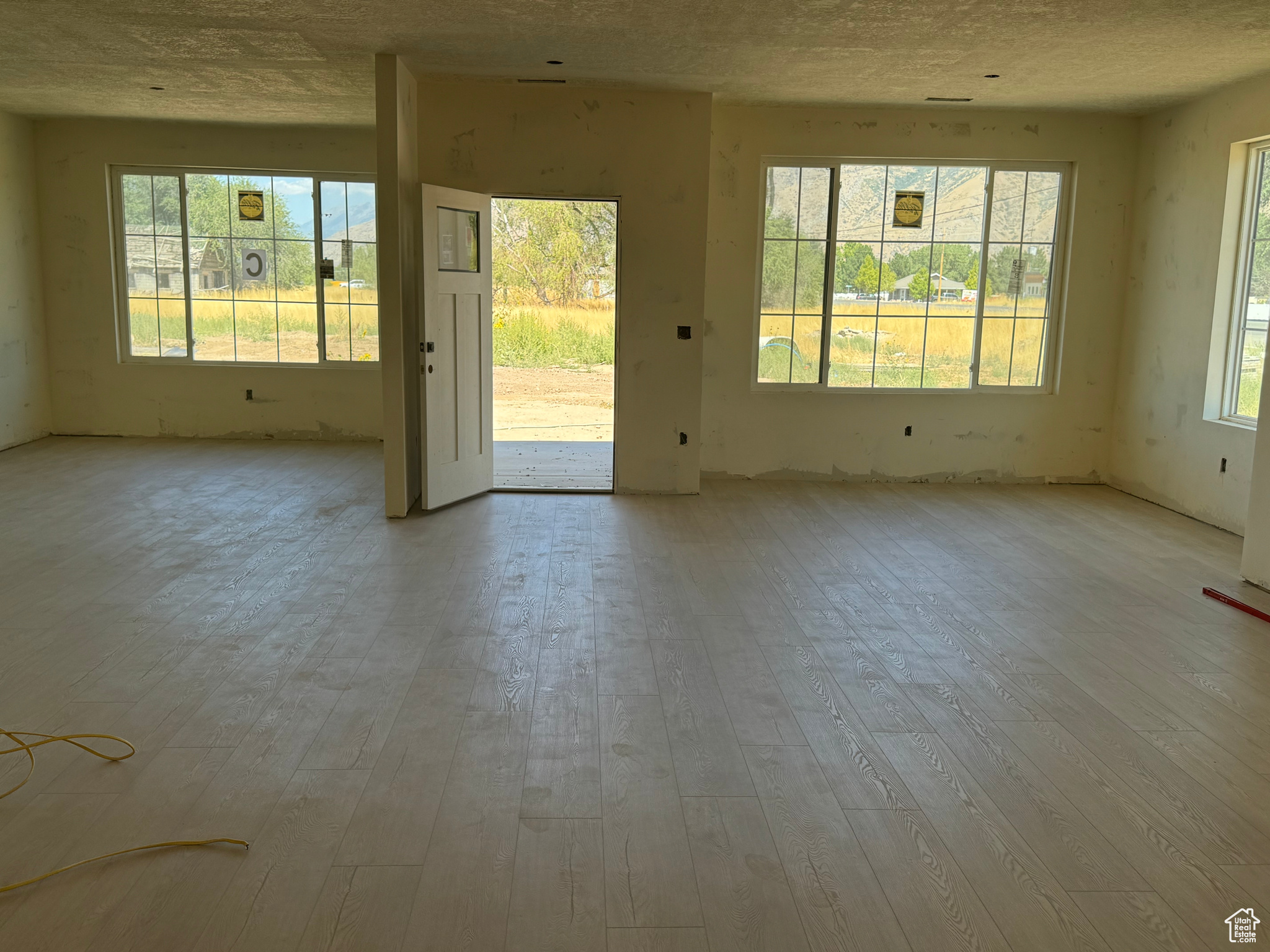 Empty room featuring a textured ceiling and hardwood / wood-style floors