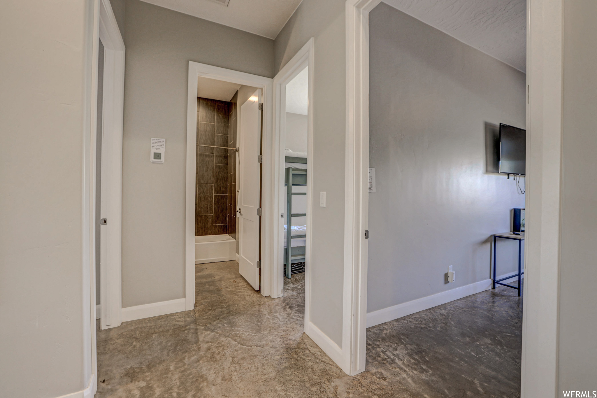 Corridor featuring tile flooring