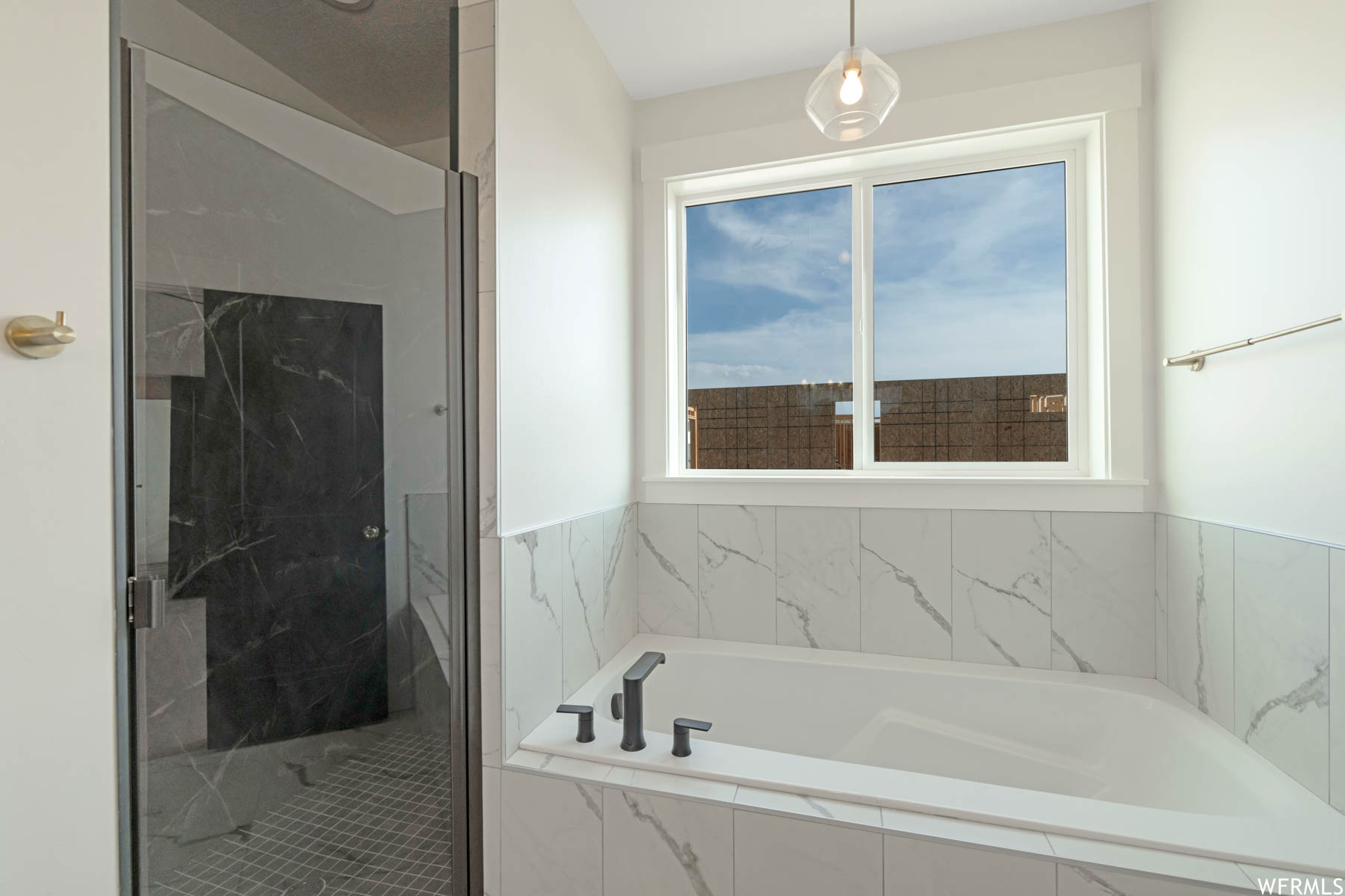 Bathroom with separate shower and tub enclosures