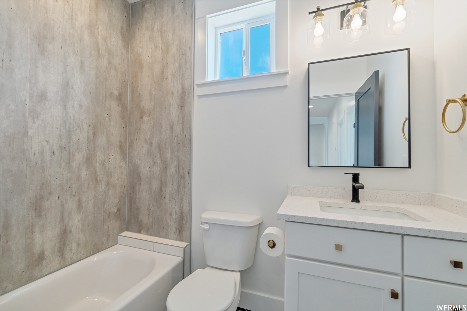 Half bathroom featuring natural light, mirror, vanity, and toilet