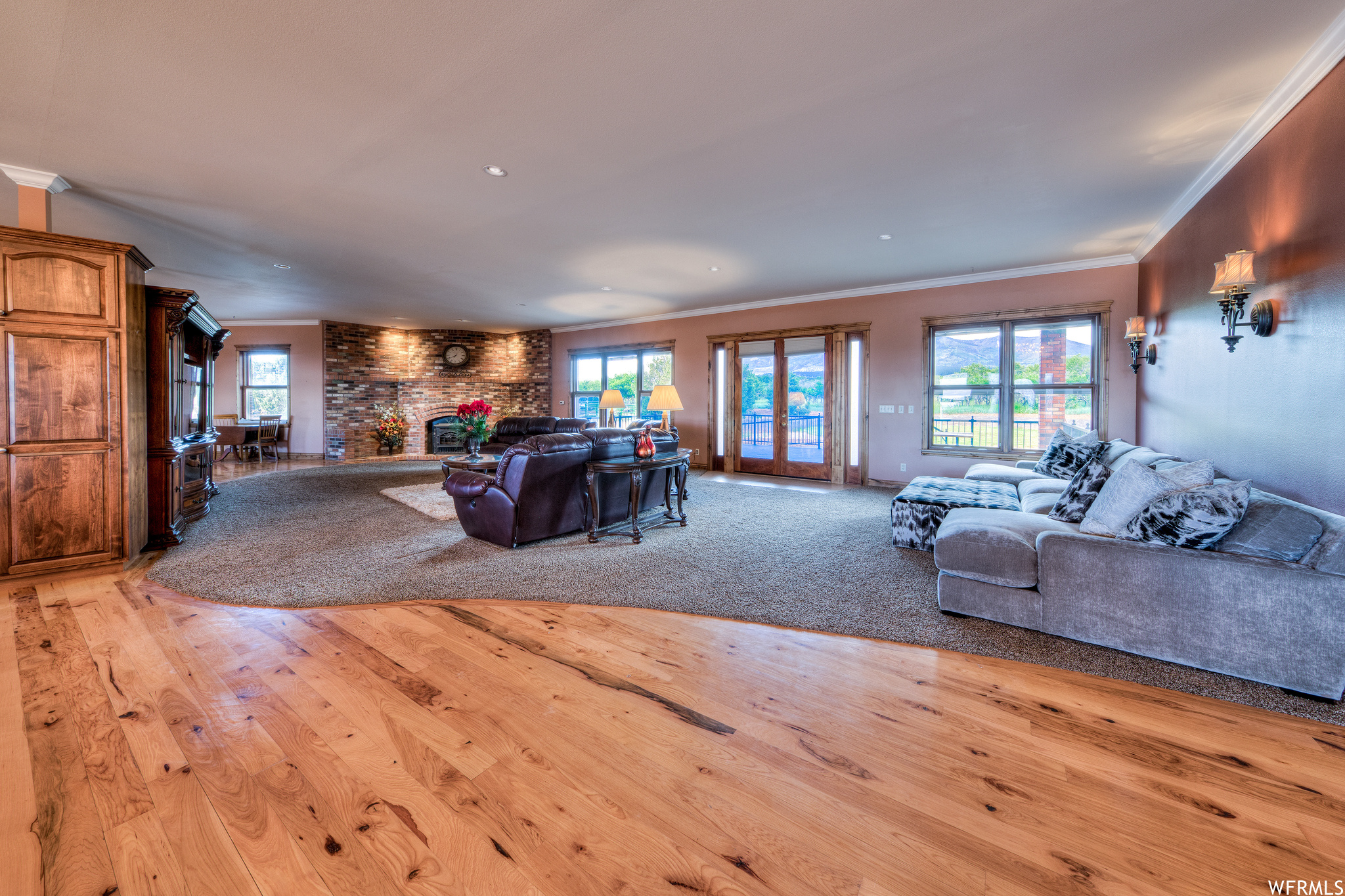 Living room featuring hardwood floors, a fireplace, and natural light