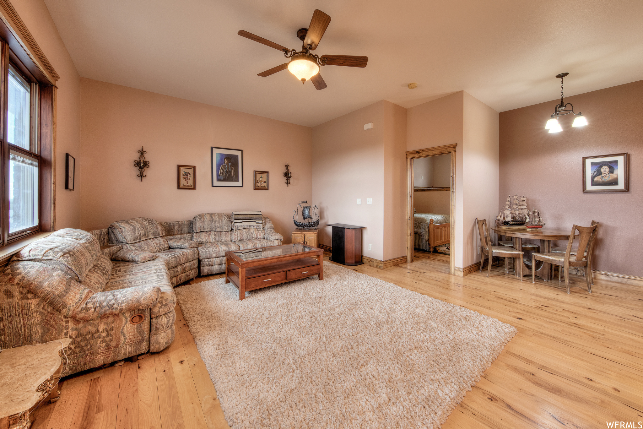 Living room with hardwood floors and a ceiling fan