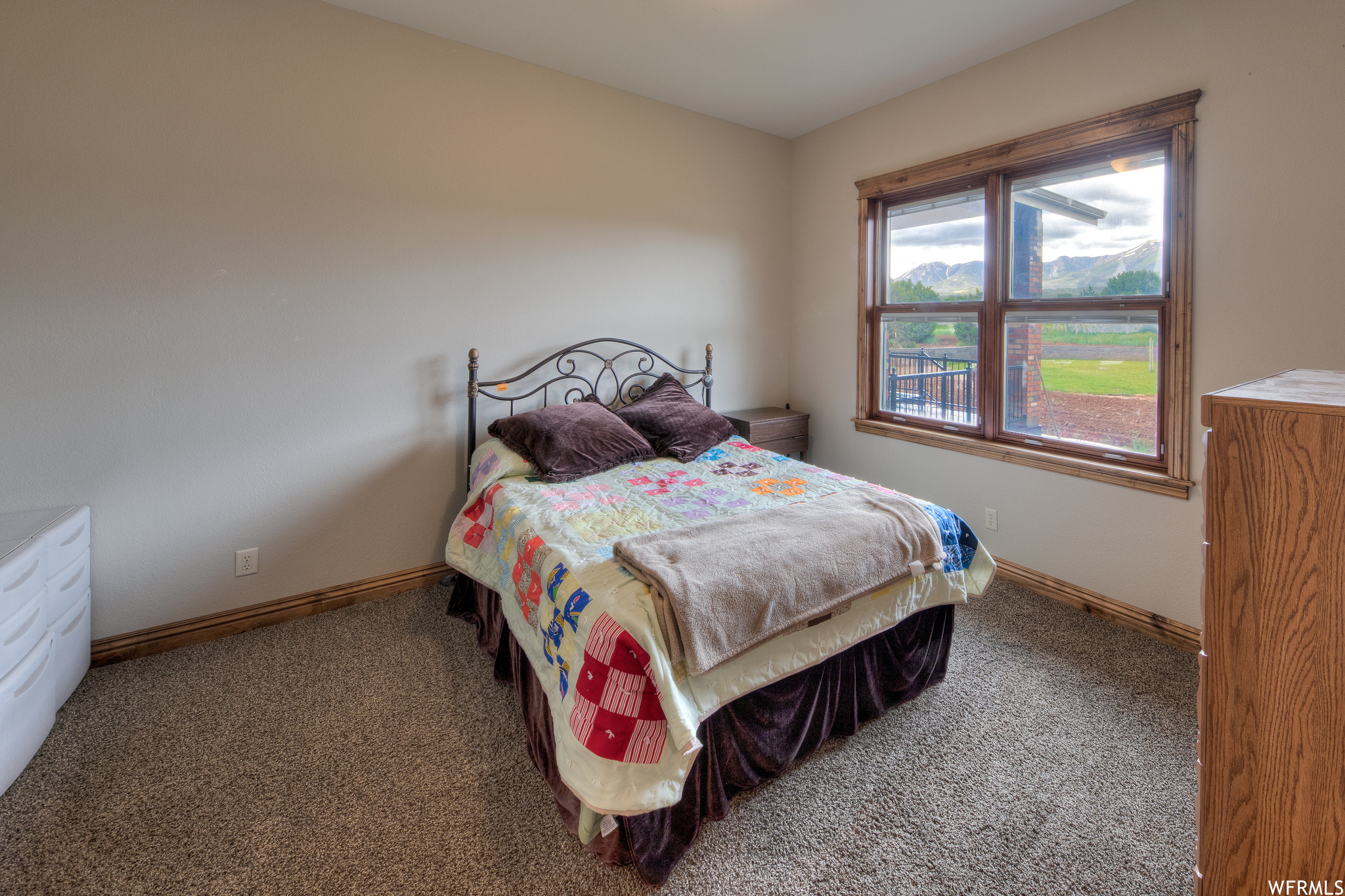 Carpeted bedroom featuring natural light