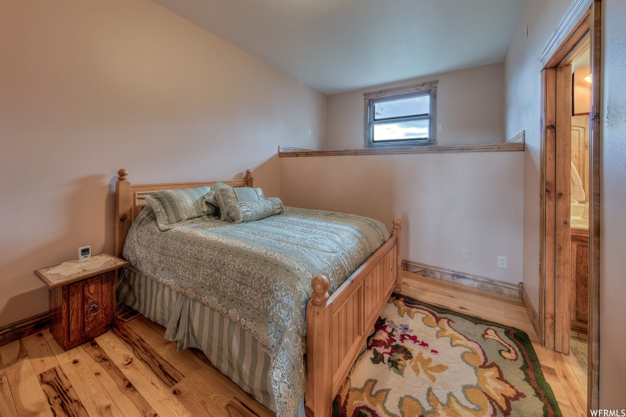 Bedroom with wood-type flooring and natural light