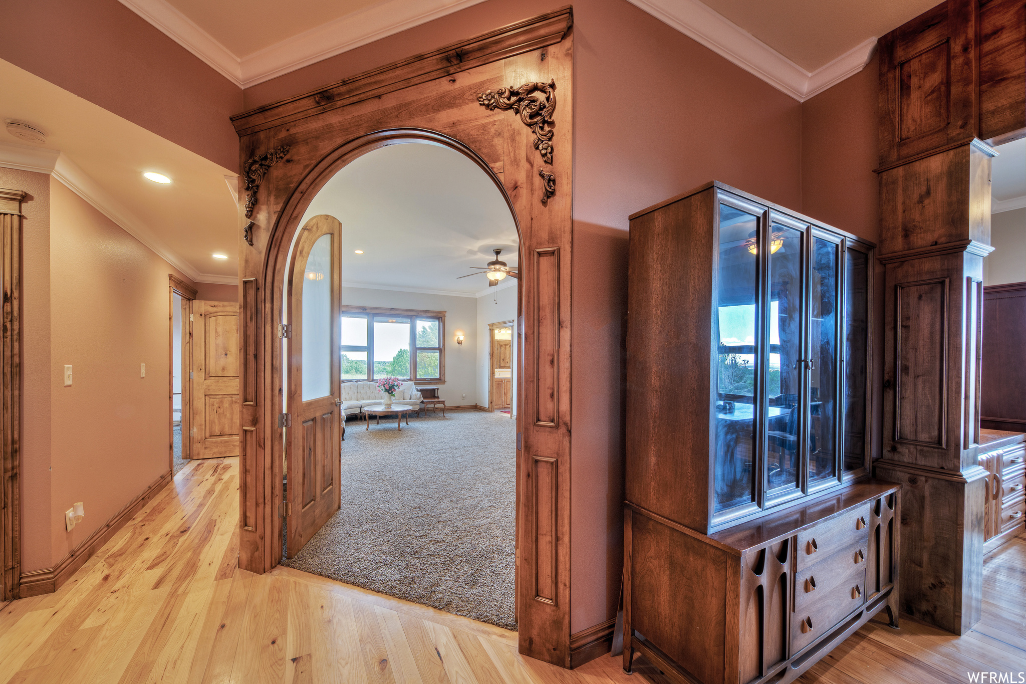 Hallway with hardwood floors and natural light