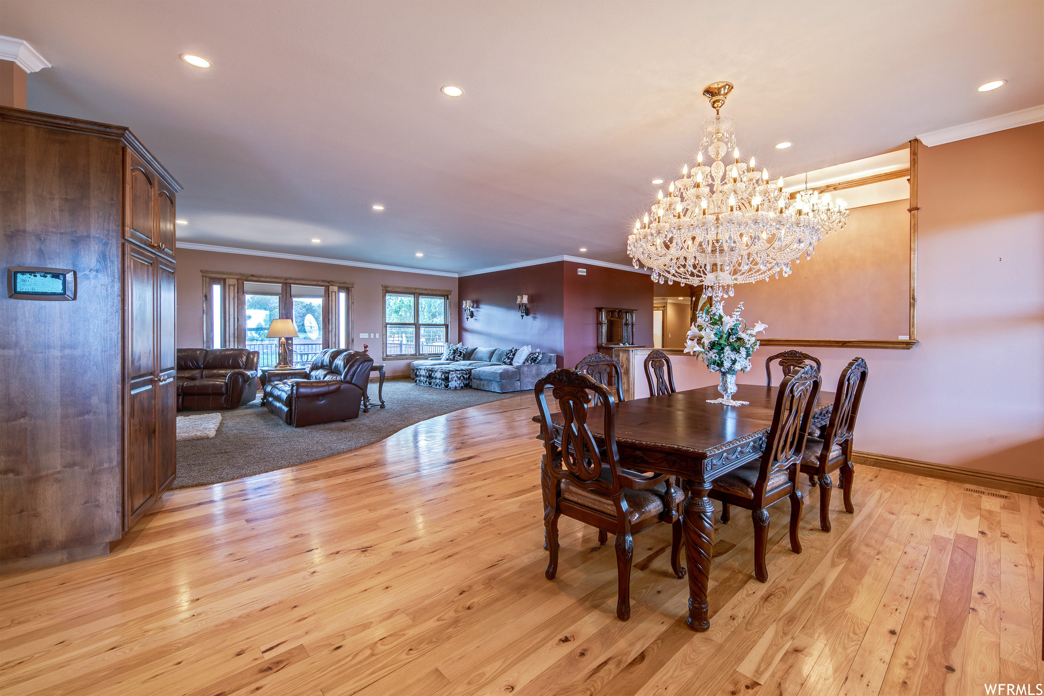 Carpeted dining space with natural light