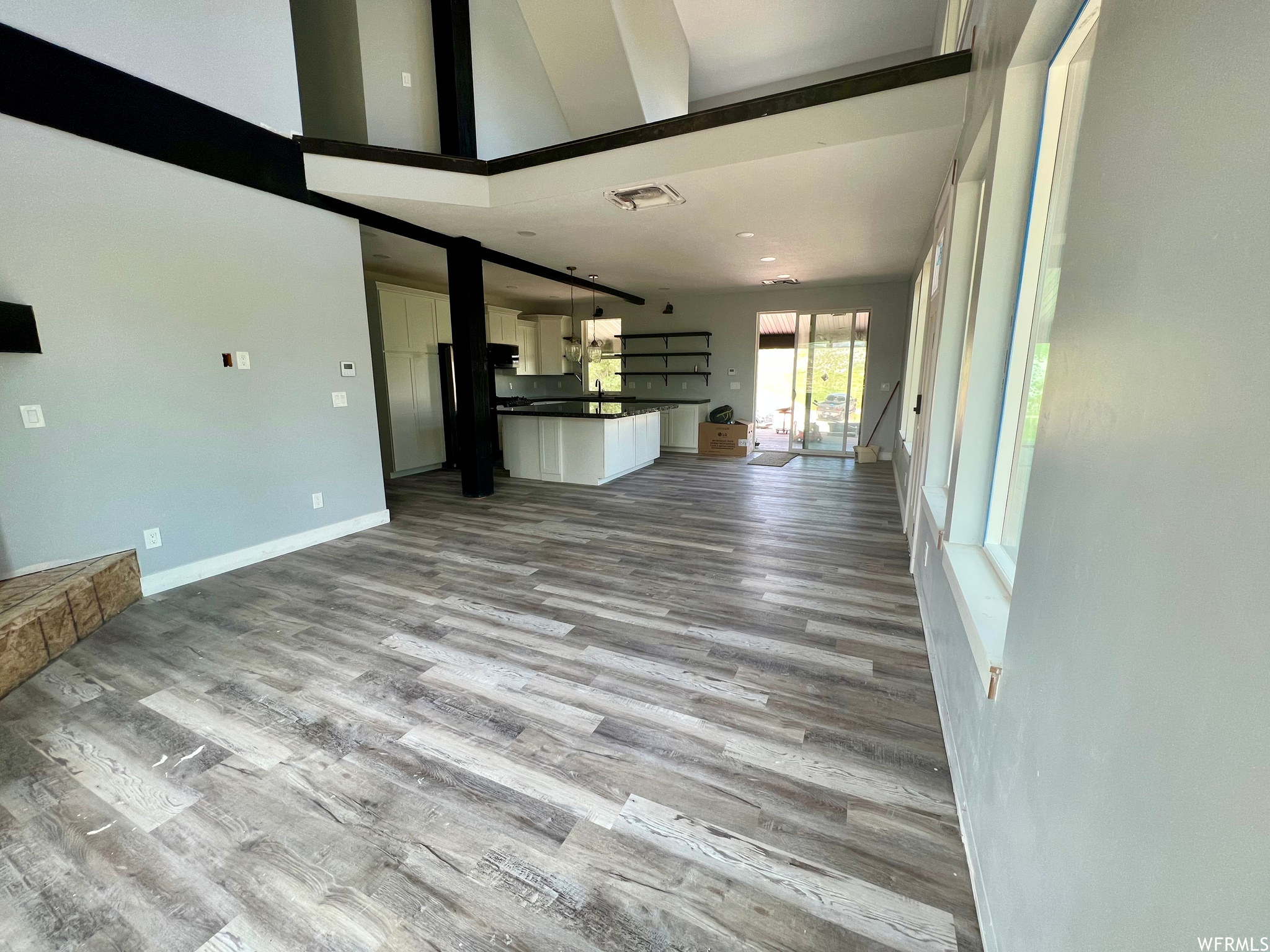 Hardwood floored living room with natural light