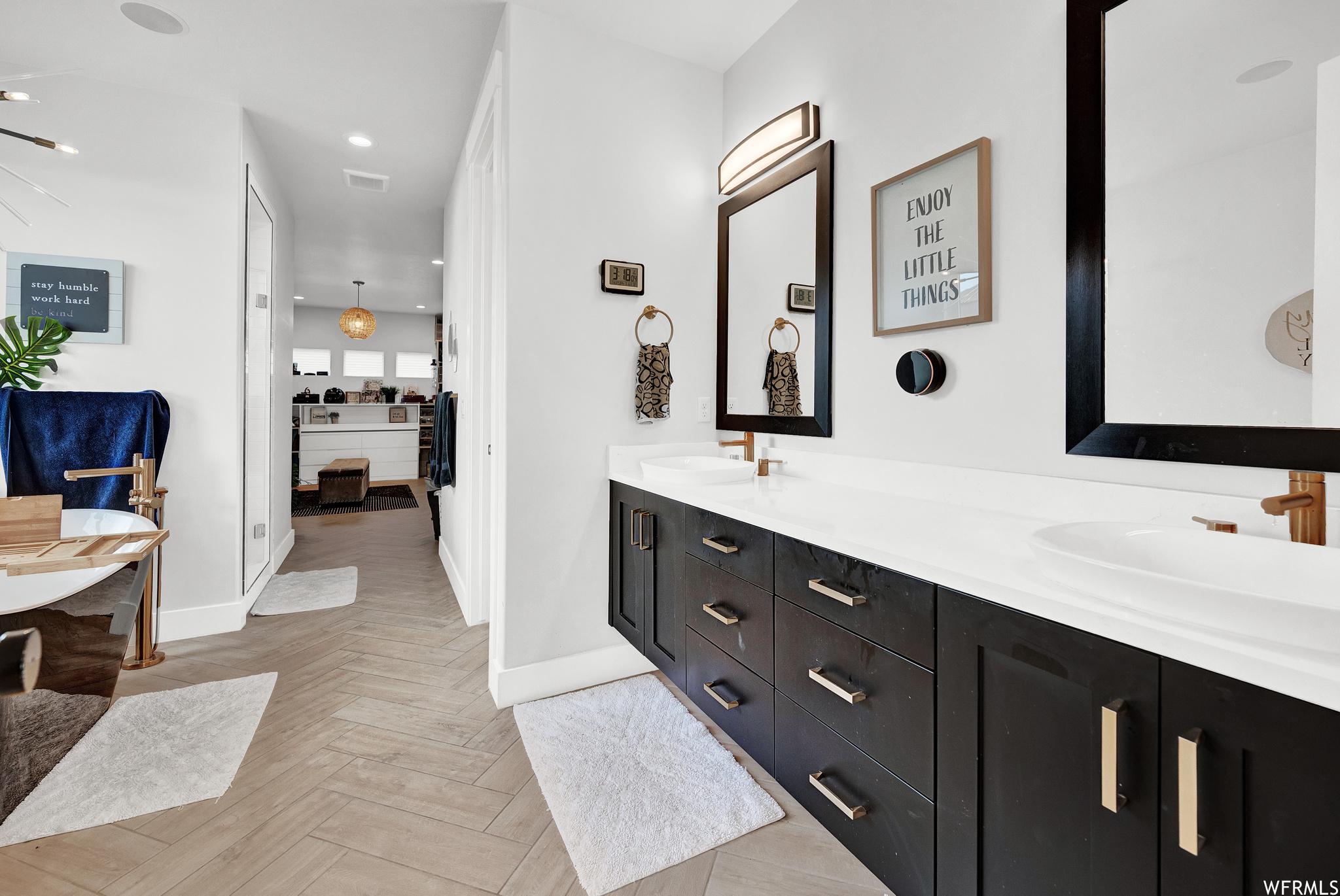 Bathroom featuring tile floors, mirror, and dual bowl vanity