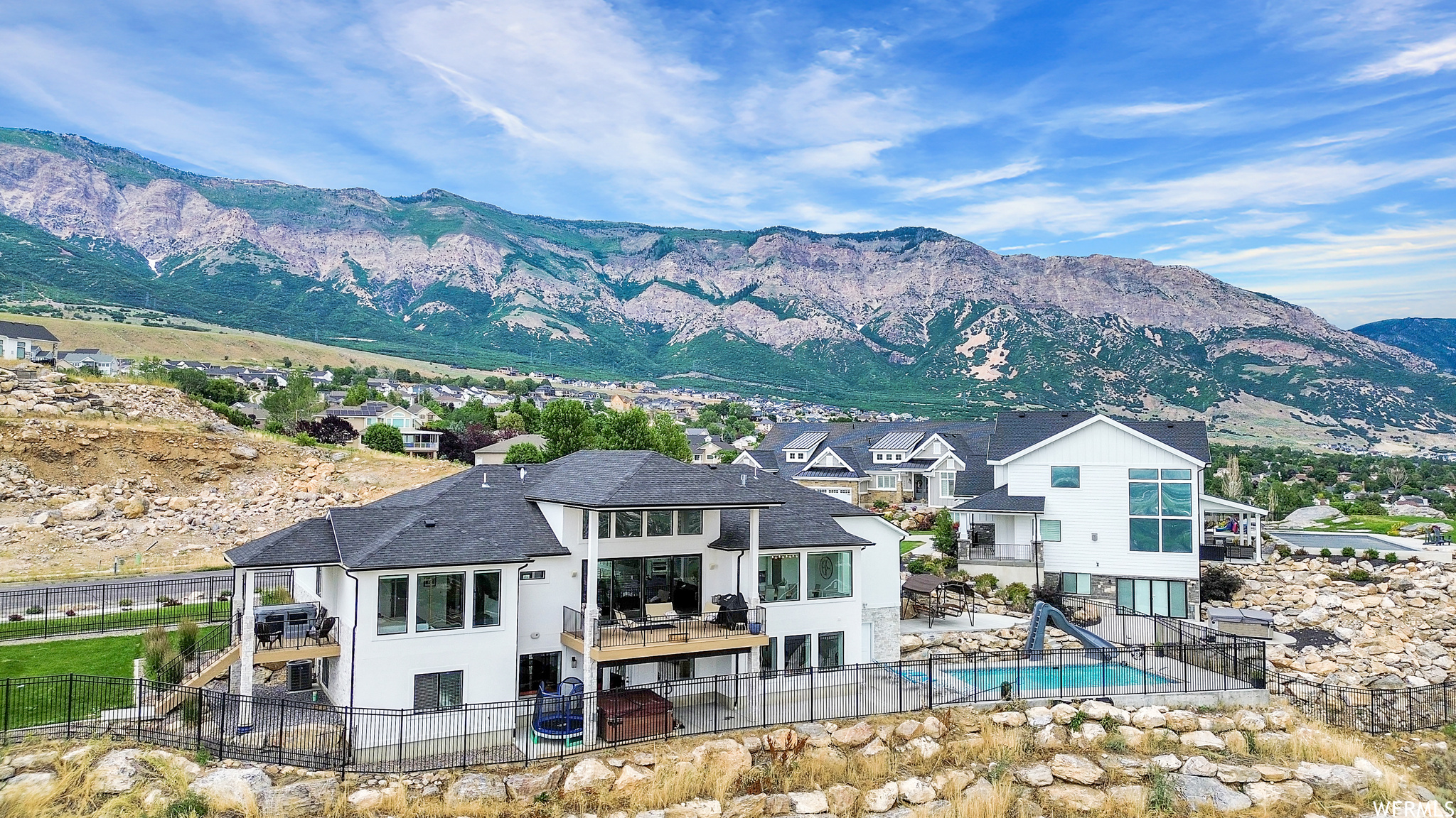Property view of mountains featuring a swimming pool