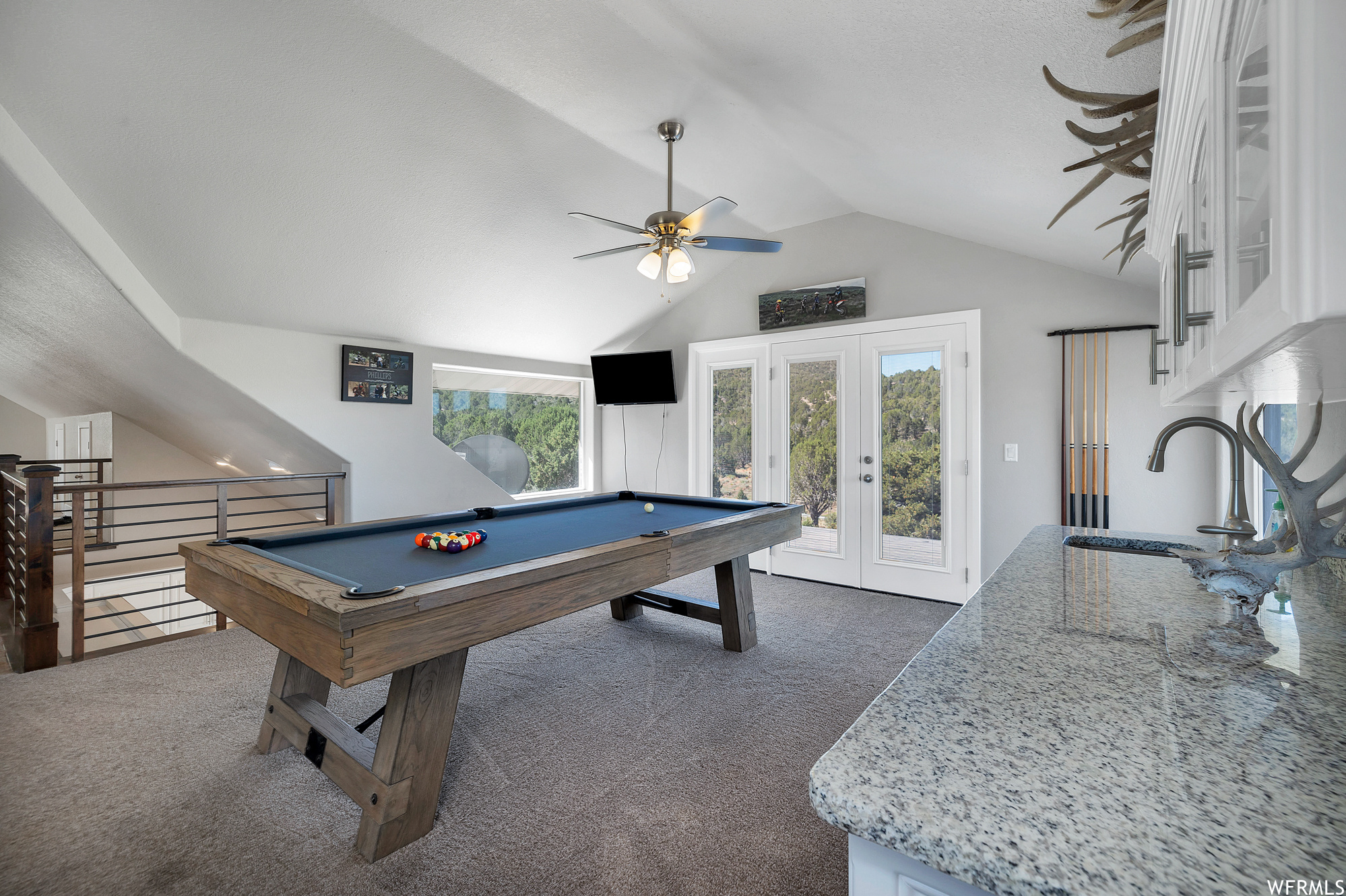 Game room with french doors, natural light, lofted ceiling, carpet