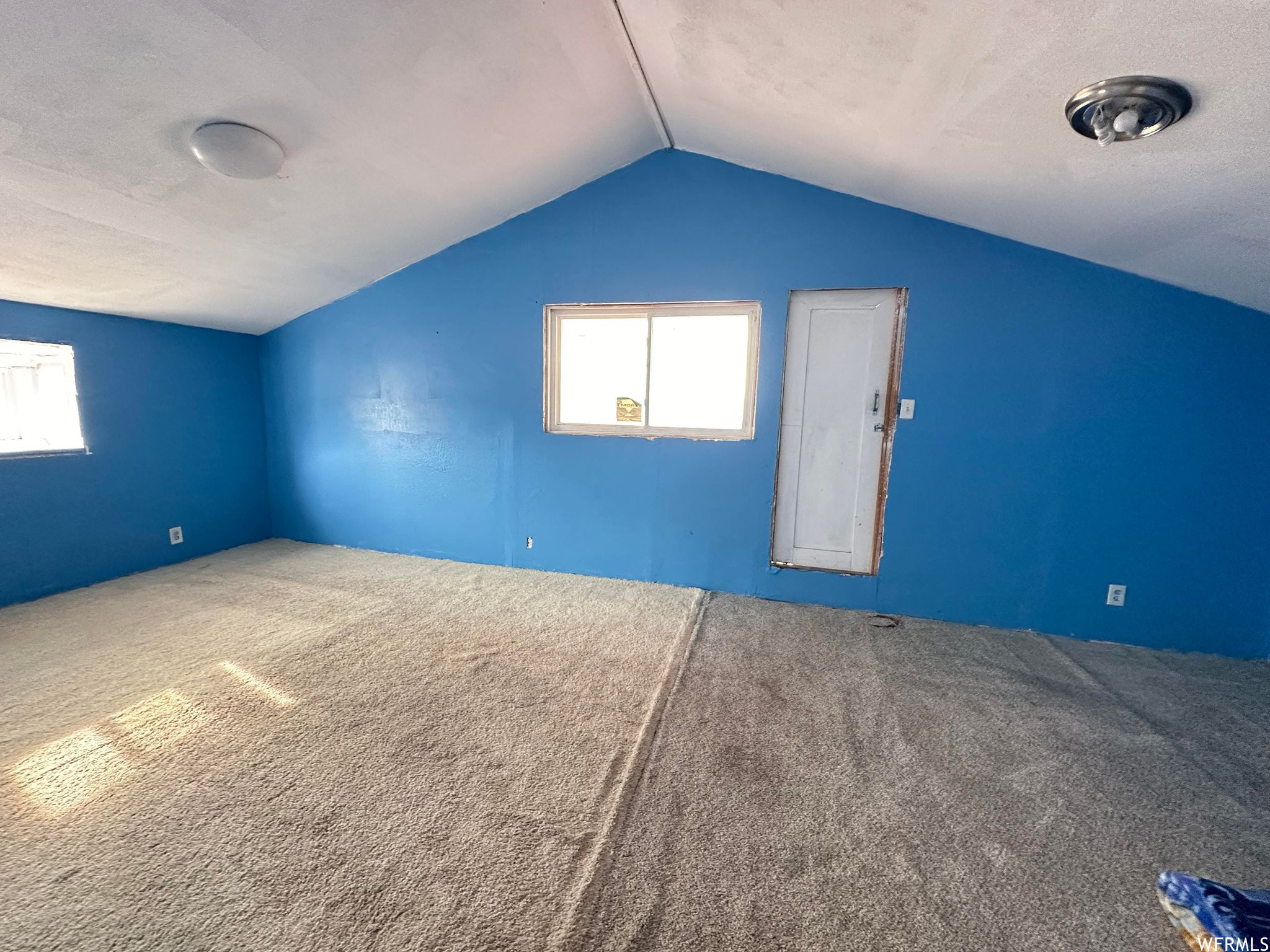 Bonus room with vaulted ceiling and carpet