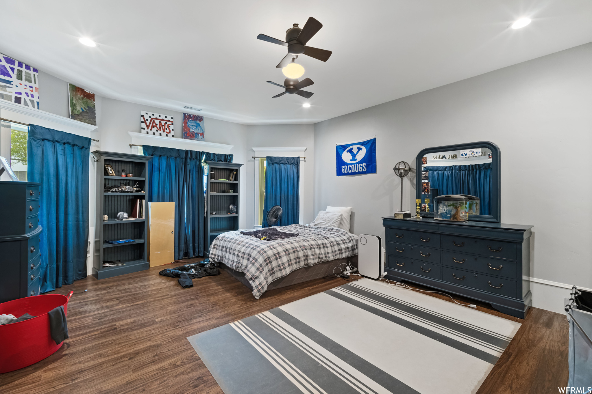 Bedroom with hardwood floors and a ceiling fan