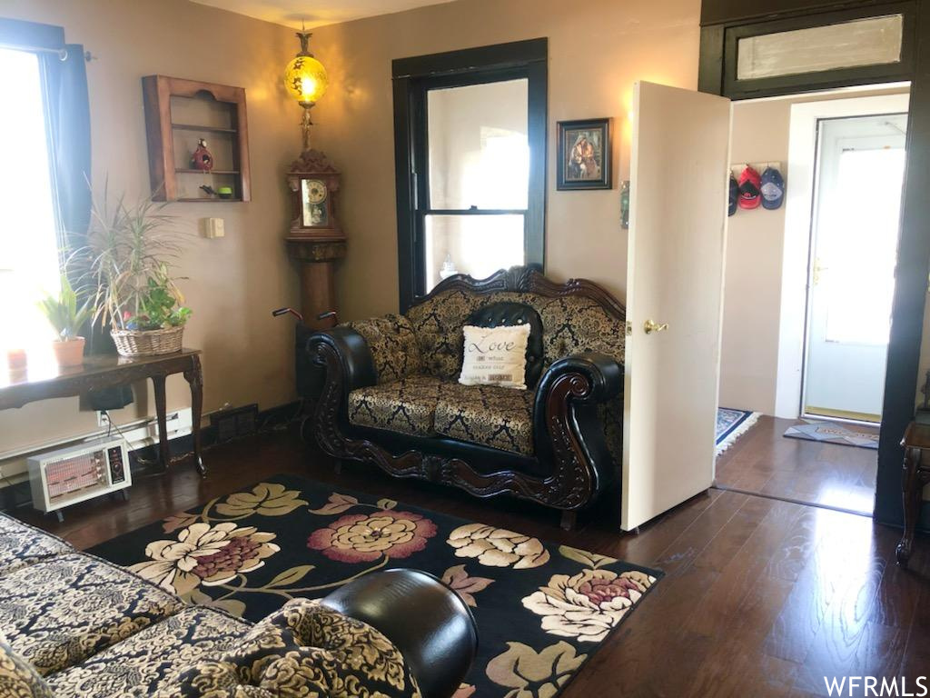 Living room with dark wood-type flooring