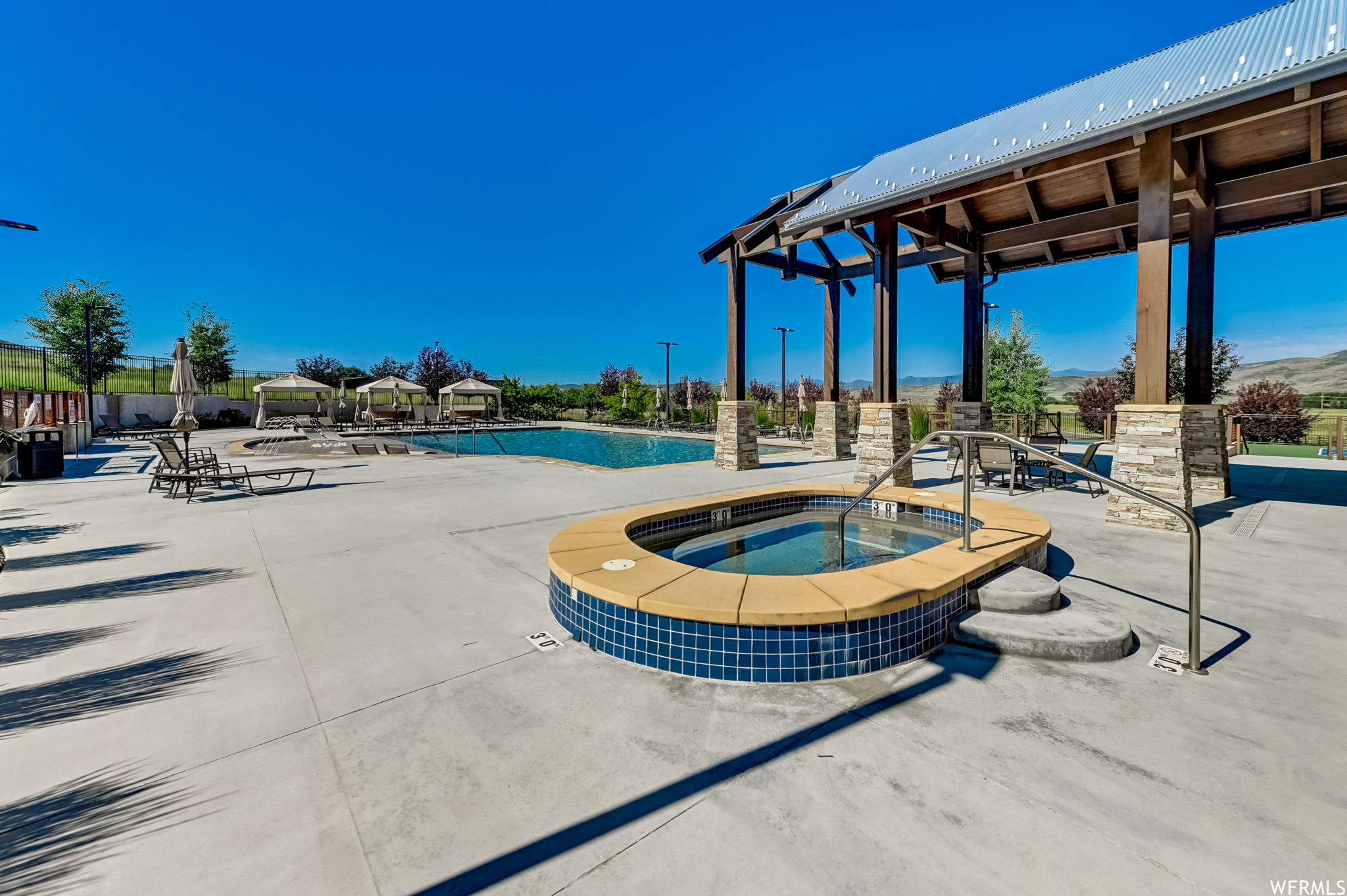 View of swimming pool with a community hot tub and a patio area
