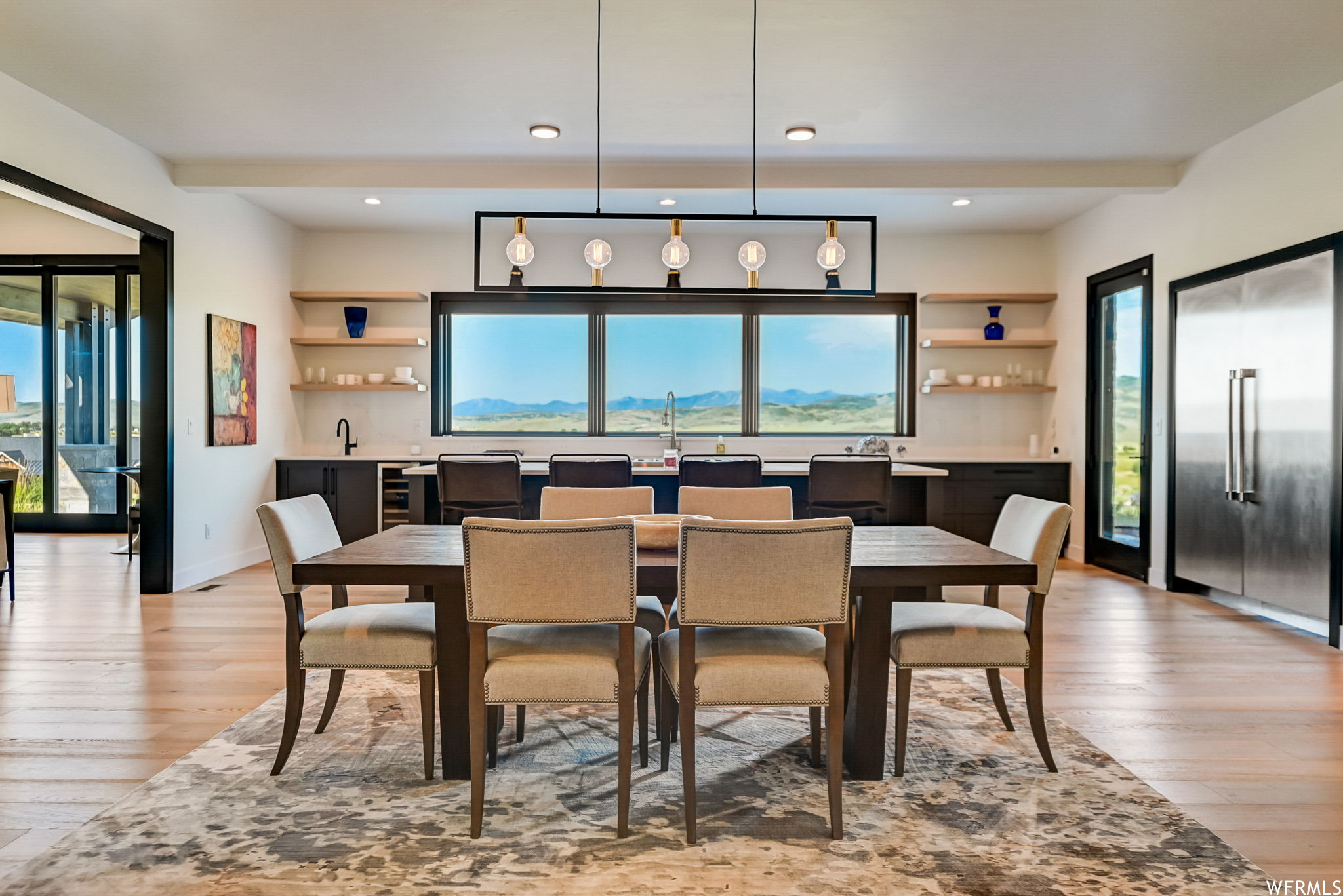 Dining area featuring light hardwood / wood-style flooring and an inviting chandelier