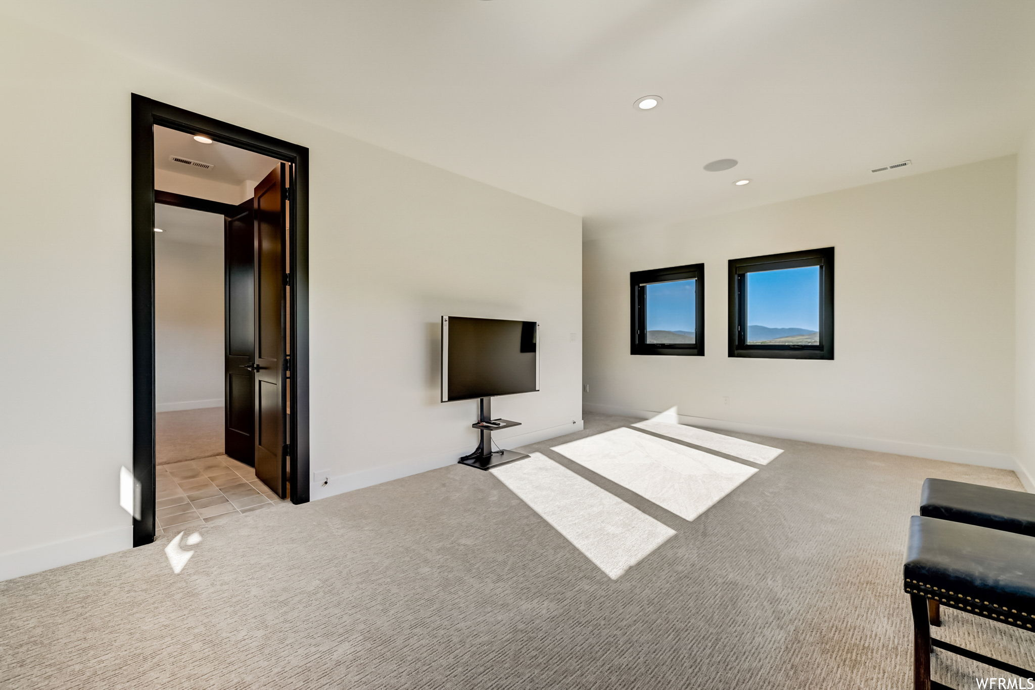 Unfurnished living room with light tile flooring