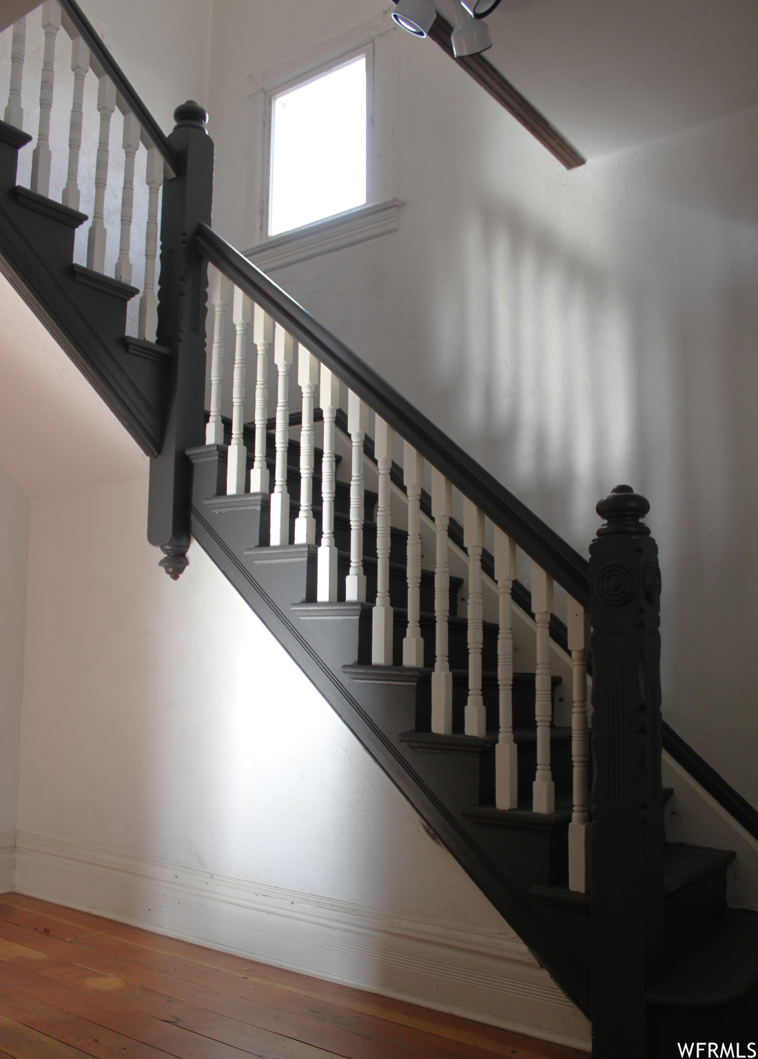Original Victorian staircase with original newels, handrails, and balusters.