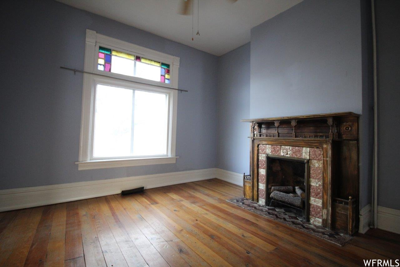 Original Victorian era fireplace now has gas log inserts.  This room would have traditionally been called the parlor and has double doors separating it from the entry and pocket doors separating it from the living room.  Works well as an office, formal di