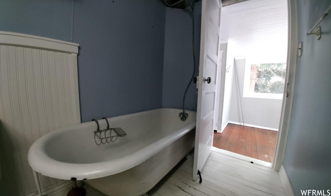 Full bath downstairs off small bedroom / mudroom area with original clawfoot tub (with shower).