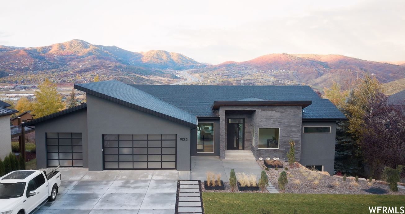 View of front of house featuring garage and a mountain view