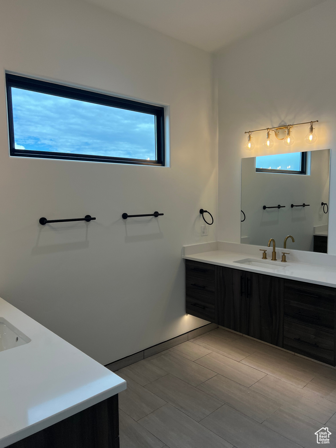 Bathroom featuring vanity, plenty of natural light, and tile flooring