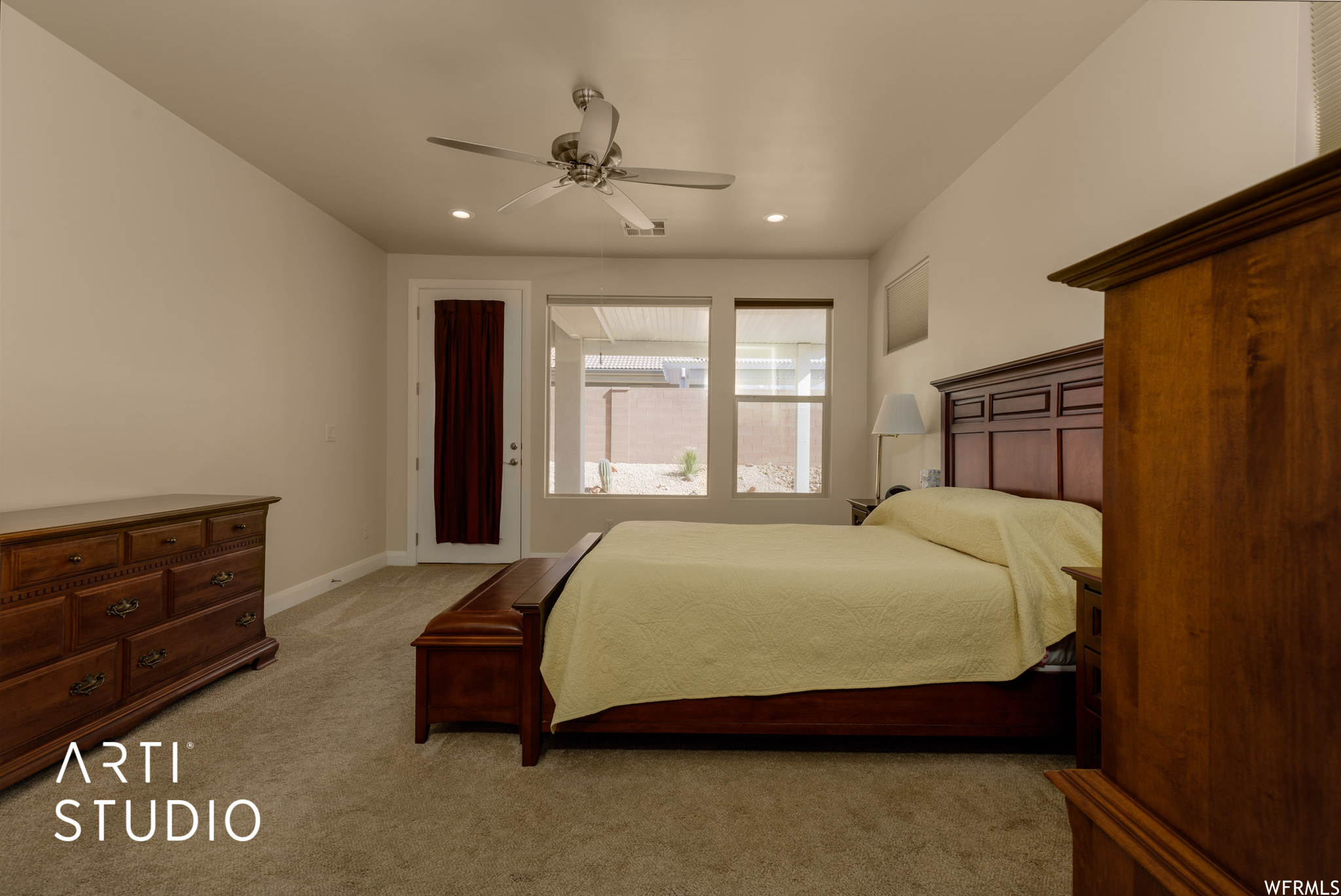 Master bedroom with light carpet and ceiling fan