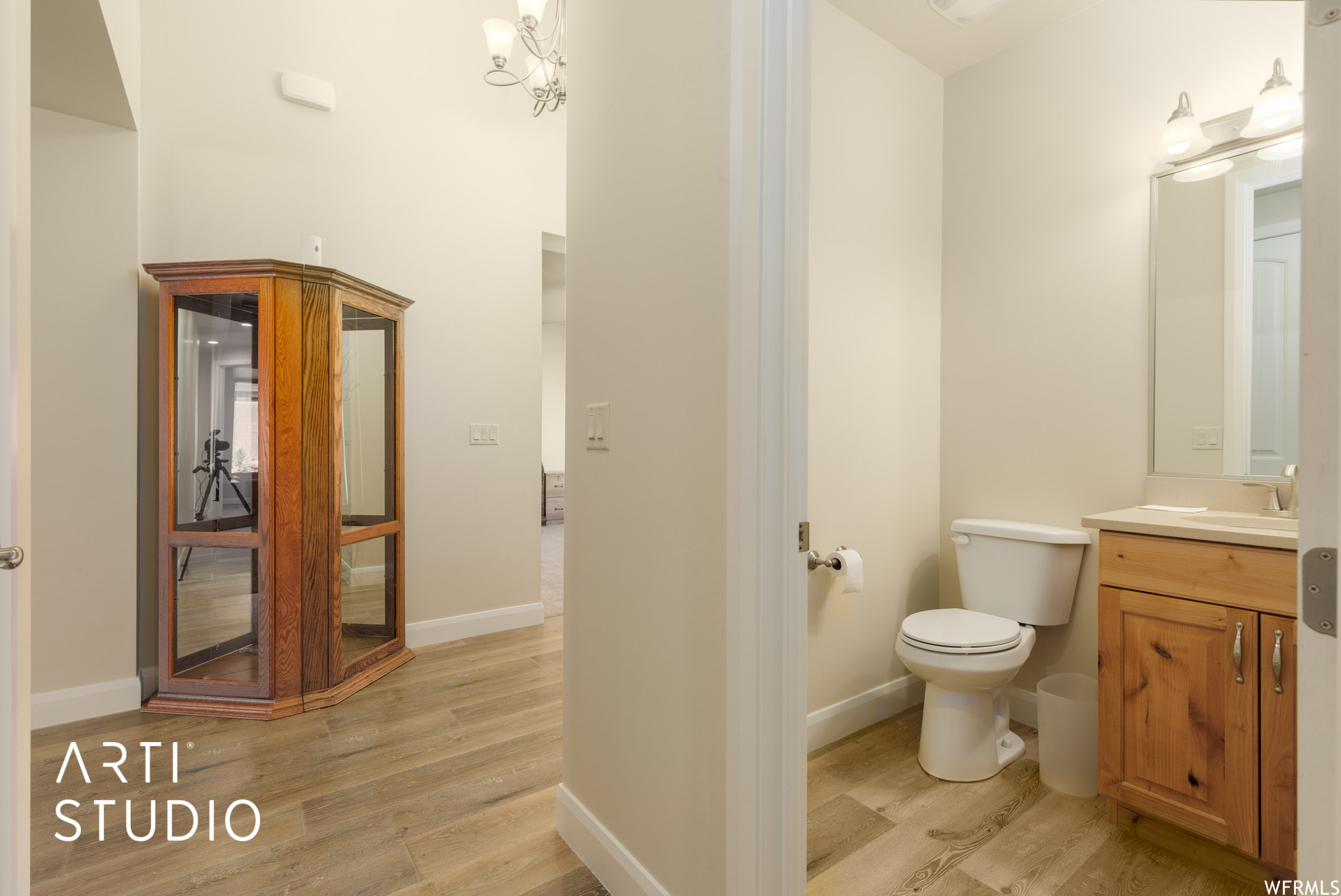 Bathroom with vanity, mirror, and light engineered wood floors