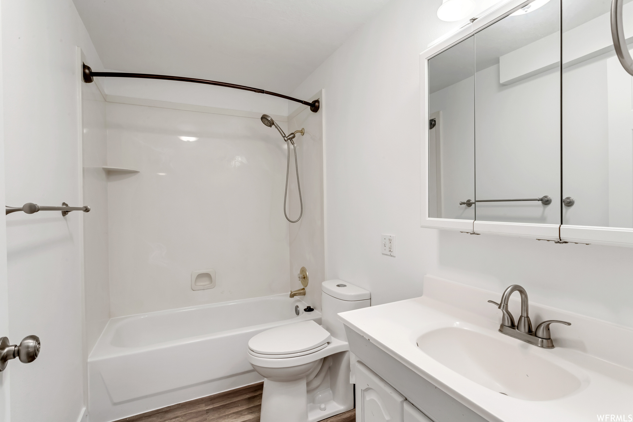 Full bathroom featuring bathtub / shower combination, hardwood floors, vanity, and mirror