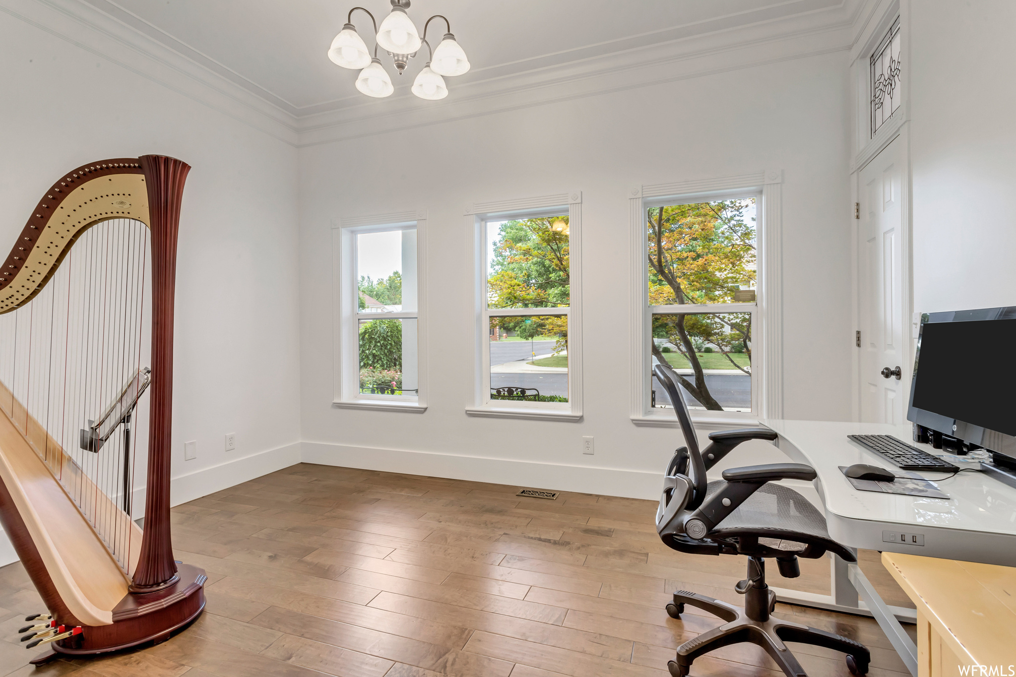 Home office featuring ornamental molding and light hardwood floors