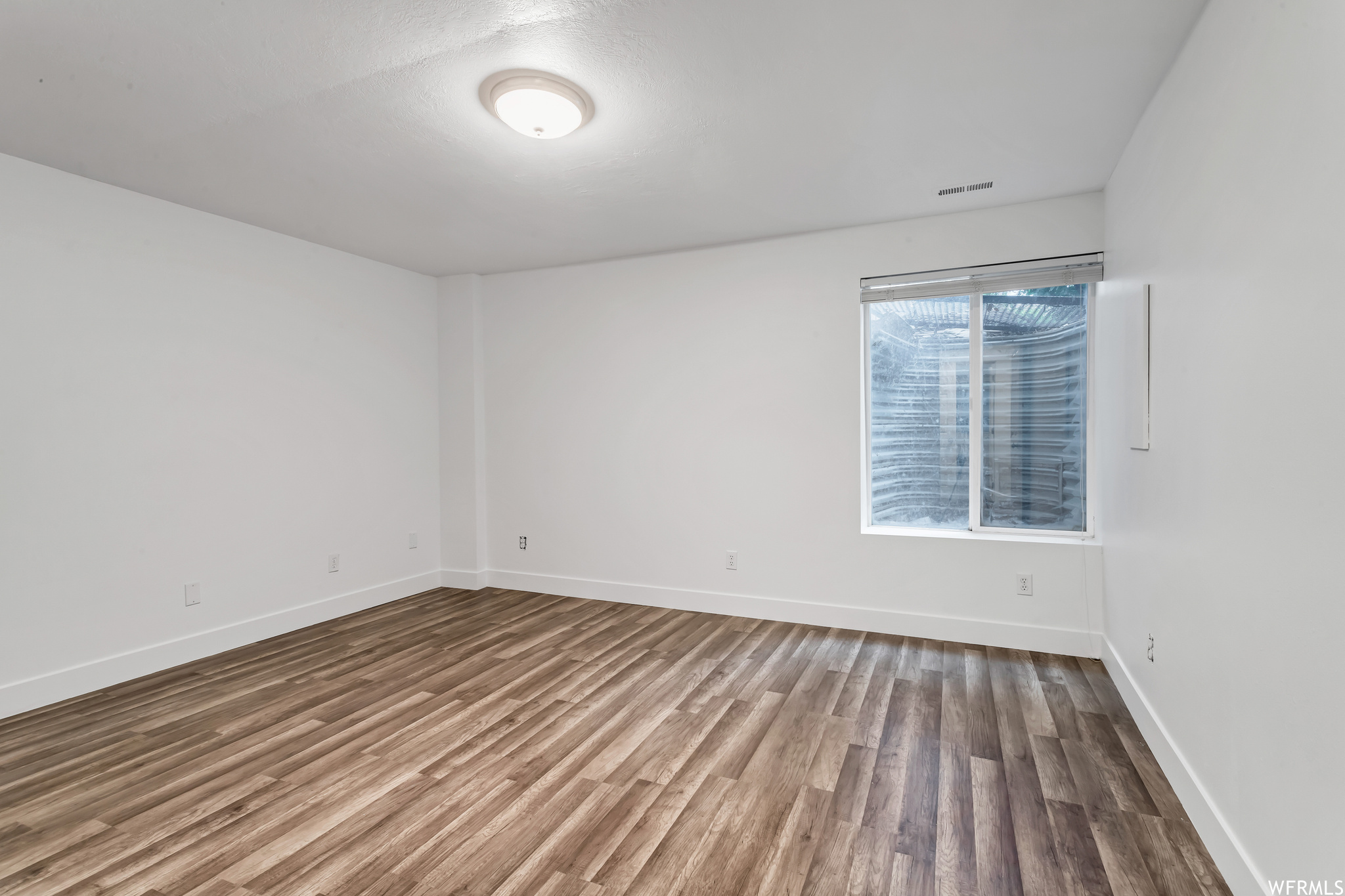 Unfurnished room featuring light hardwood floors