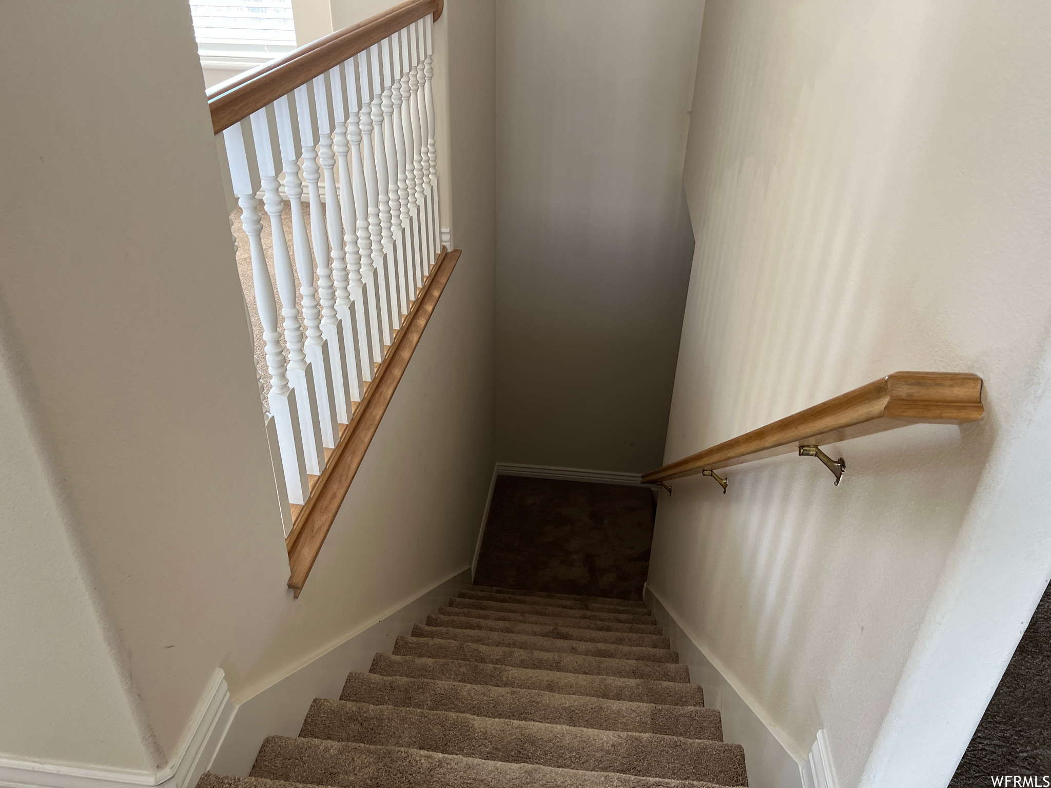 Stairway featuring dark carpet