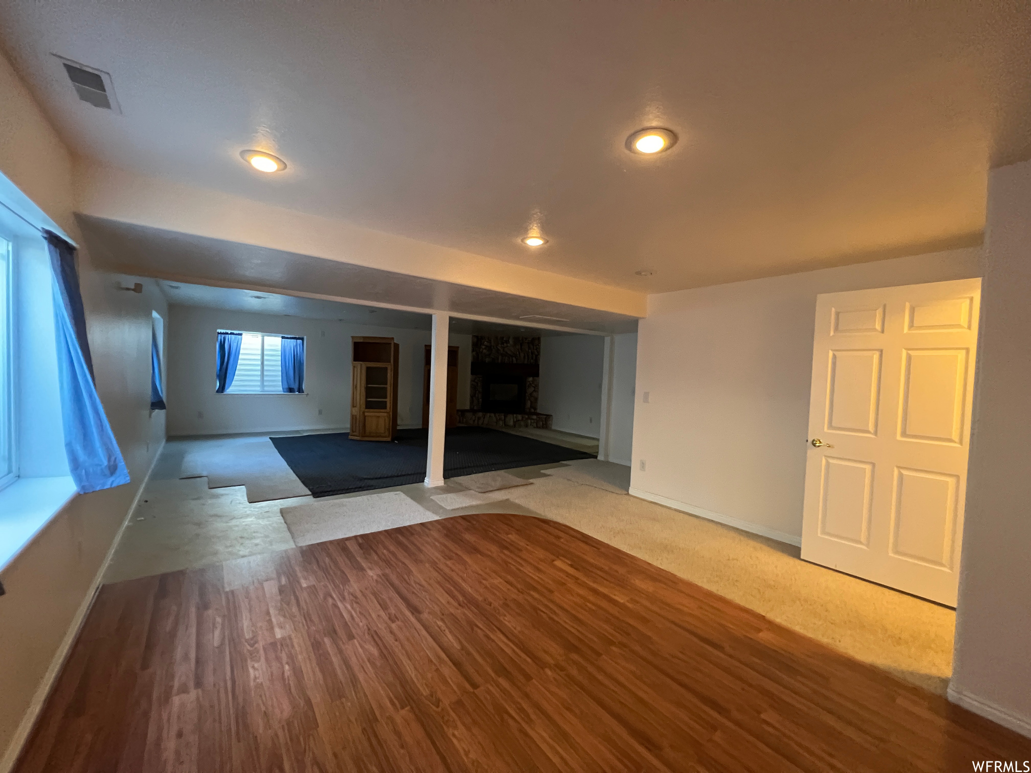 Hardwood floored living room featuring a fireplace