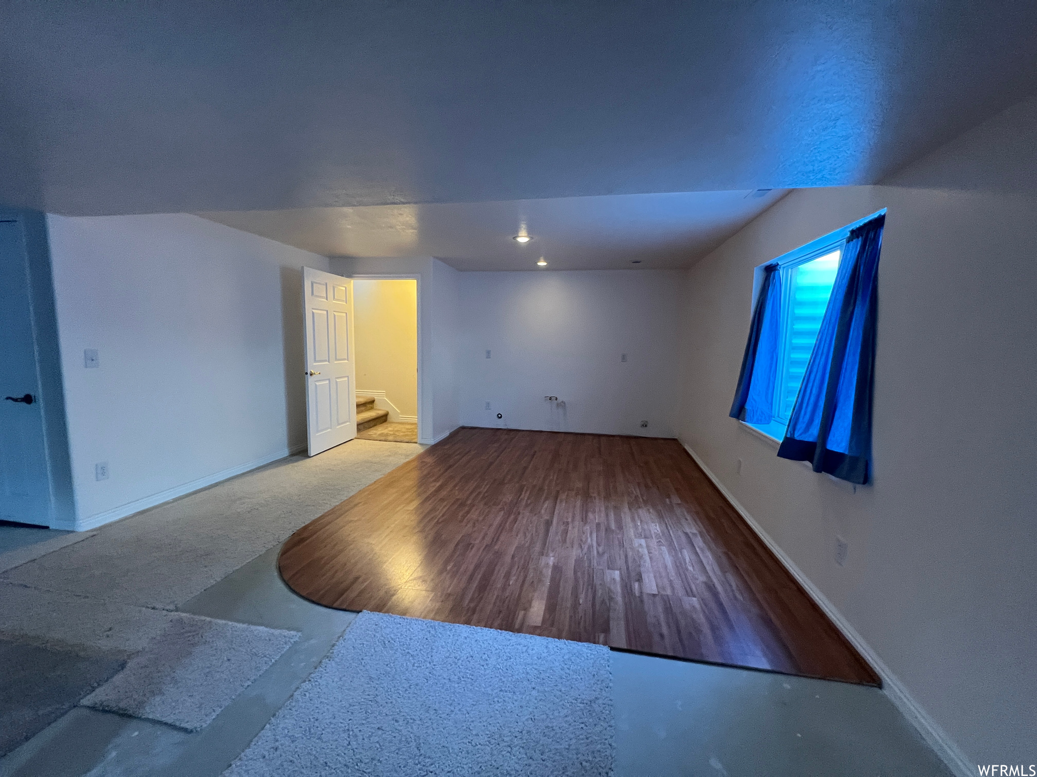 Unfurnished room featuring hardwood floors