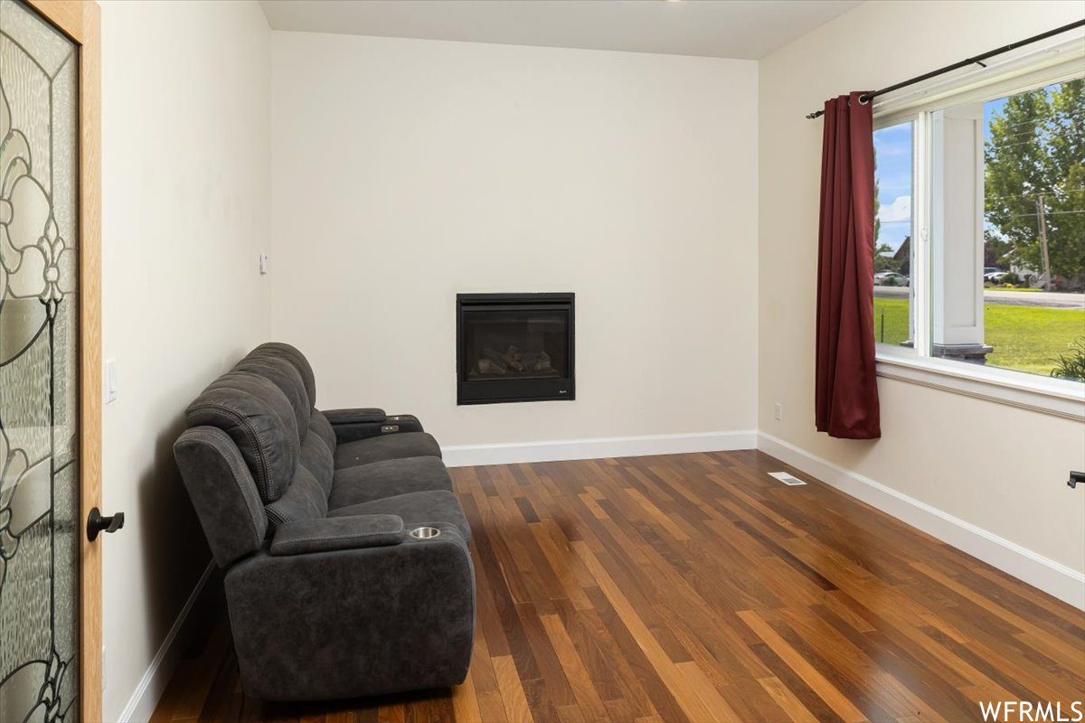 Sitting room featuring dark wood-type flooring