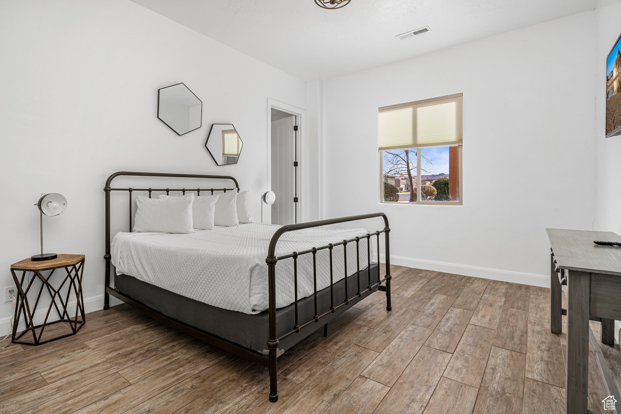 Bedroom with light hardwood / wood-style flooring