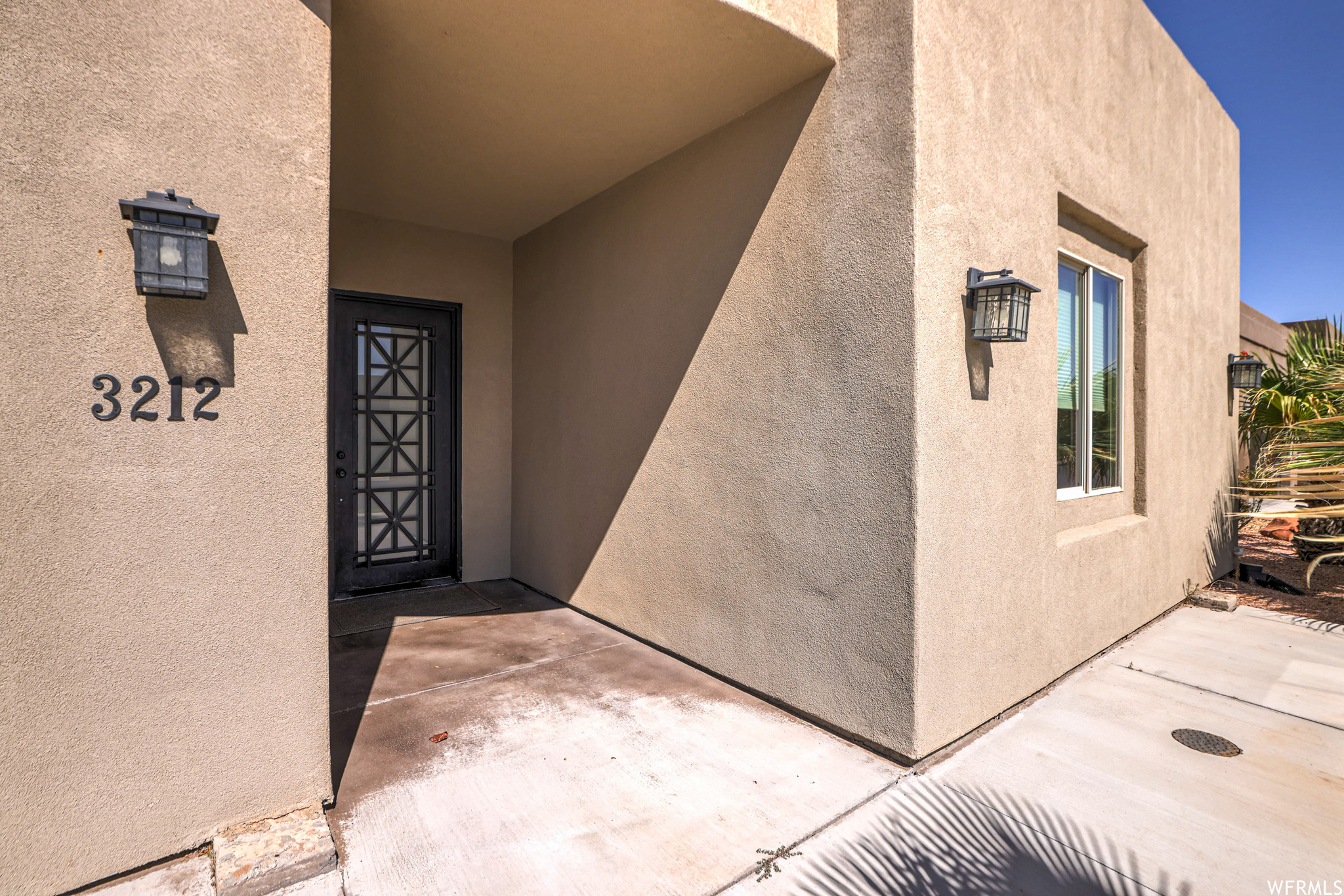 Doorway to property featuring a patio