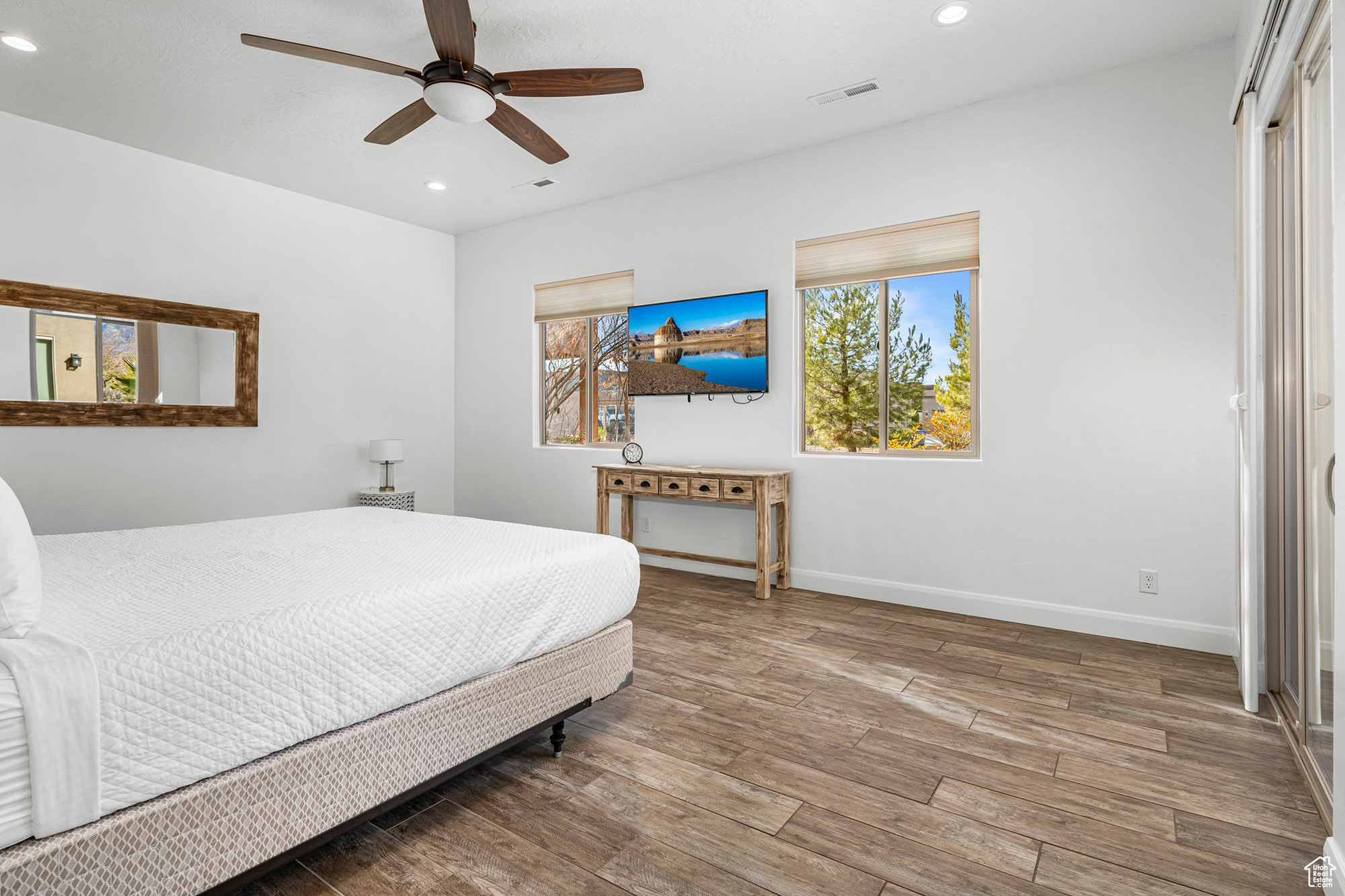 Bedroom featuring hardwood / wood-style flooring and ceiling fan