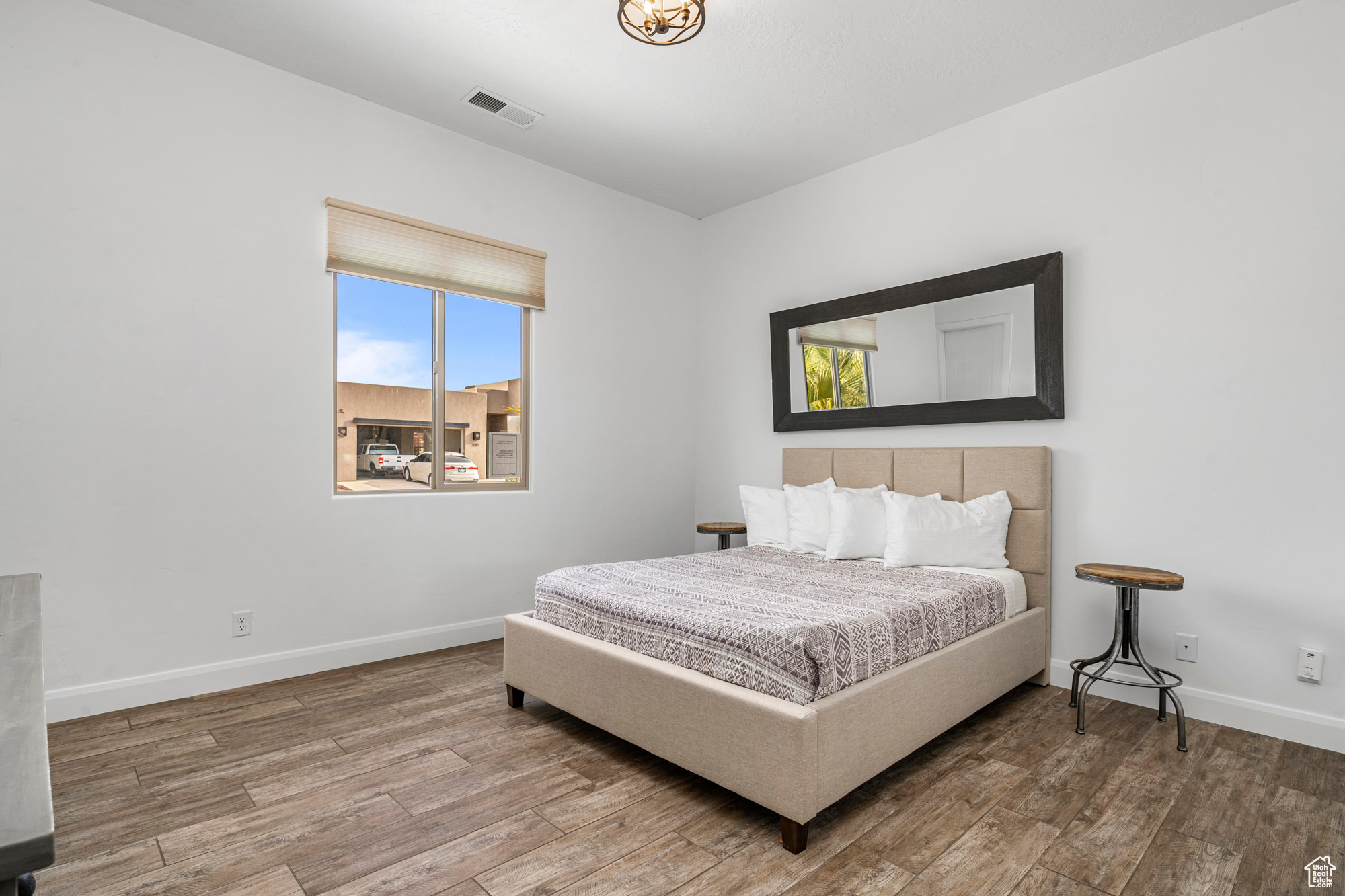 Bedroom with hardwood / wood-style flooring