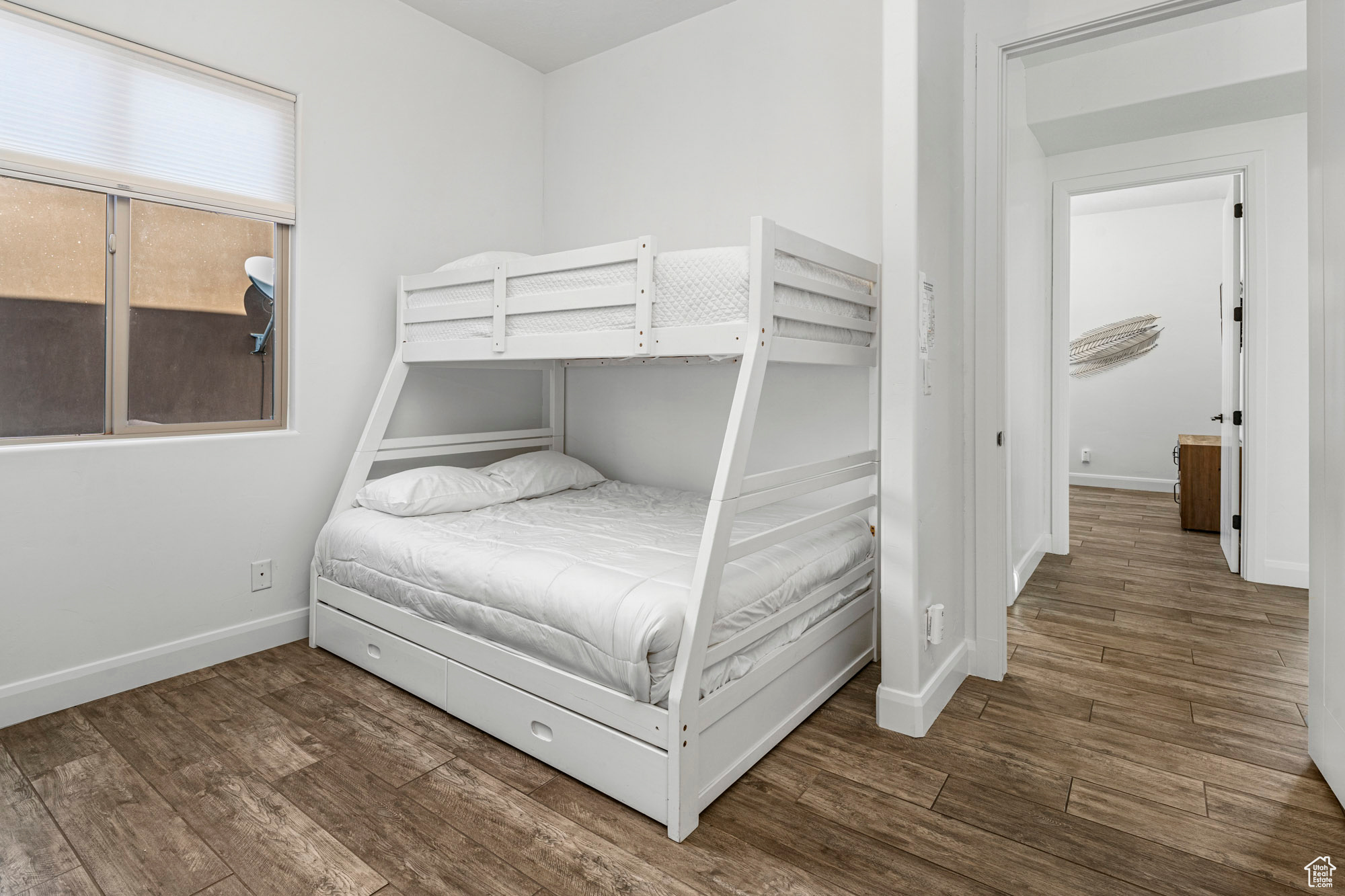 Unfurnished bedroom with dark wood-type flooring