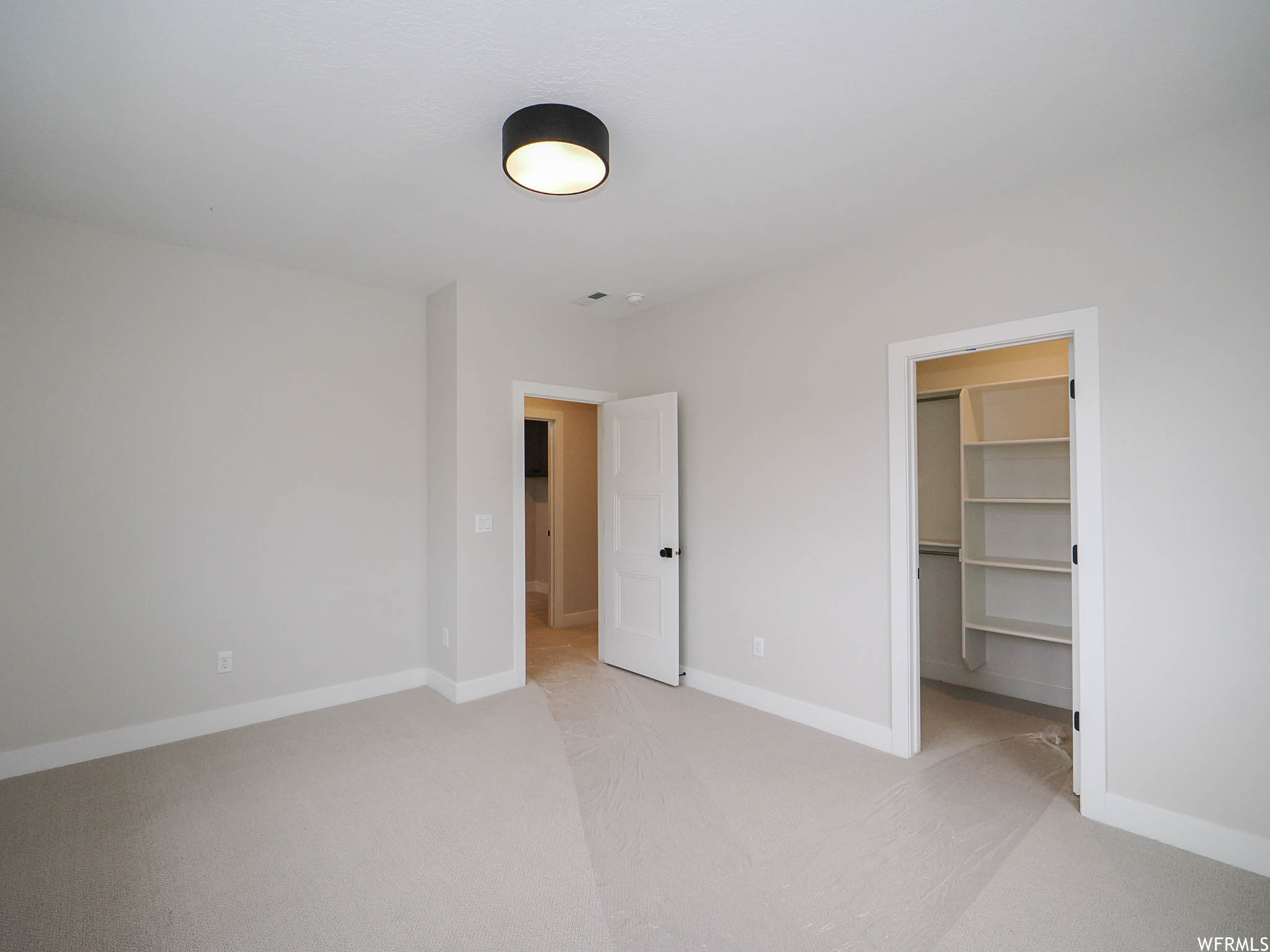 Bedroom with light carpet