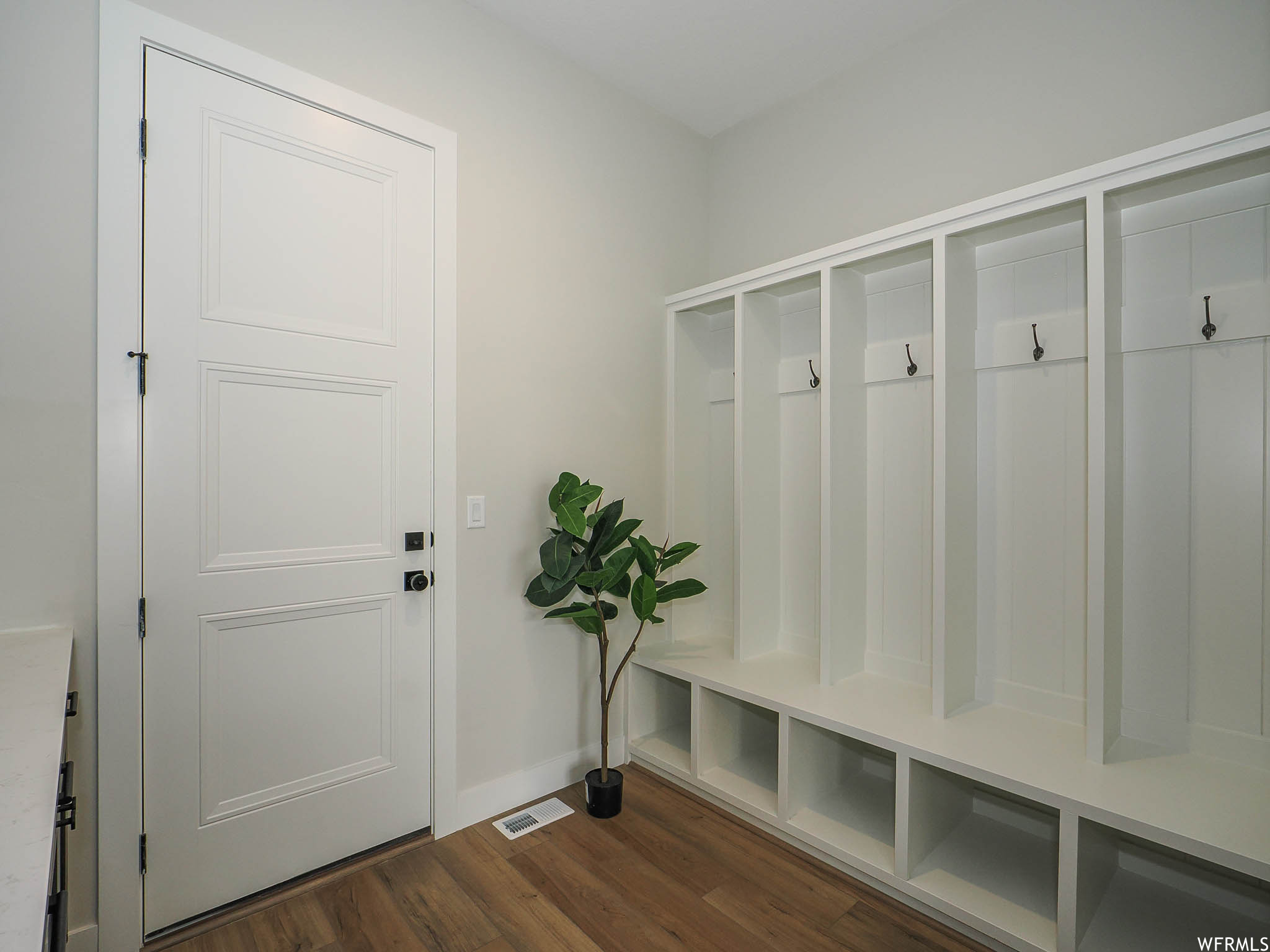 Mudroom featuring hardwood floors