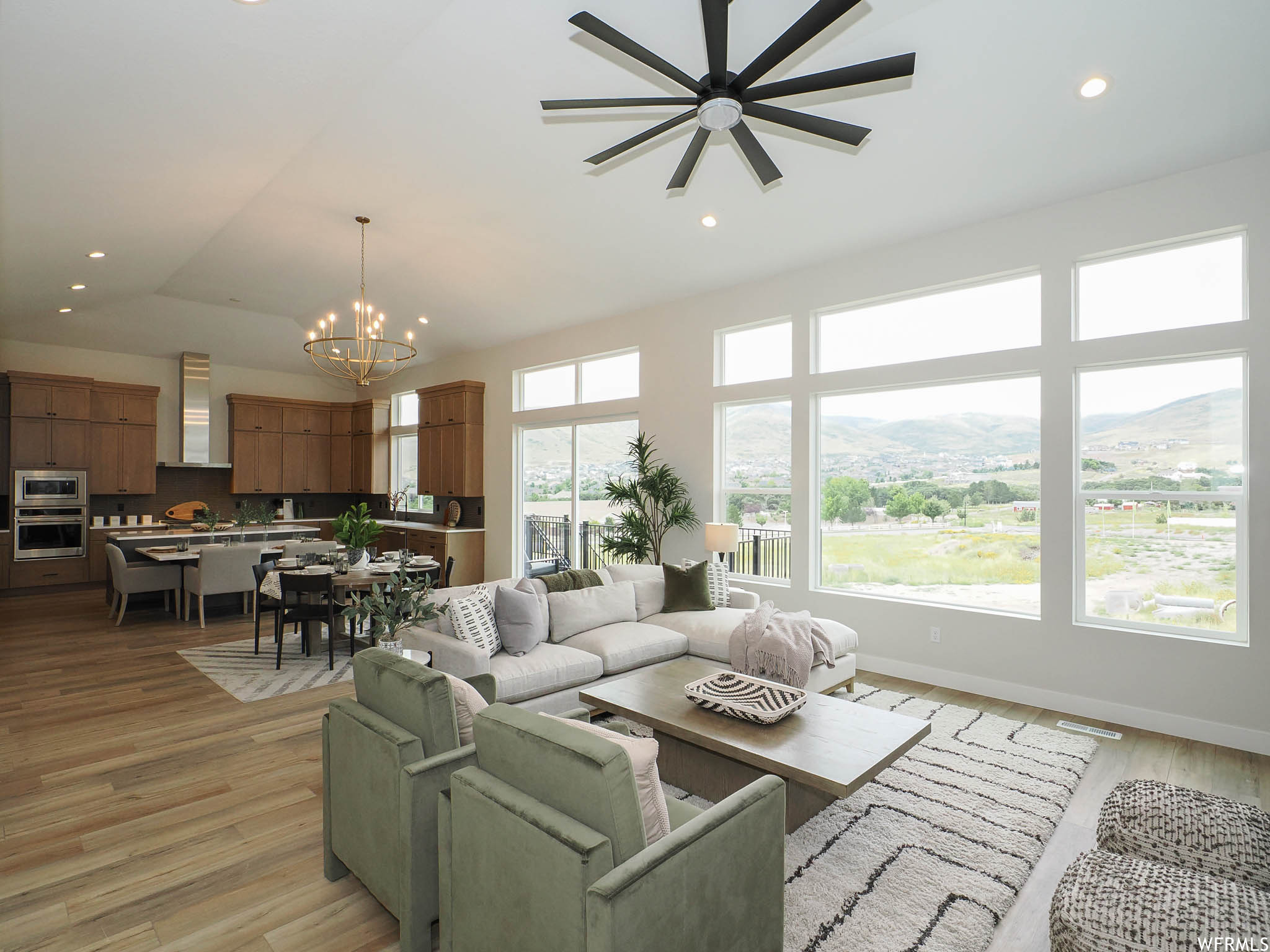 Hardwood floored living room featuring ceiling fan